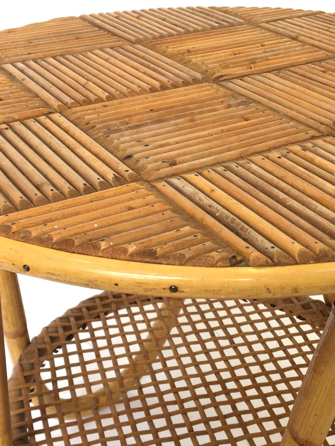 French Riviera side table in bamboo and cane circa 1950, a bamboo topped table with cane under tier on a curved tripod base.