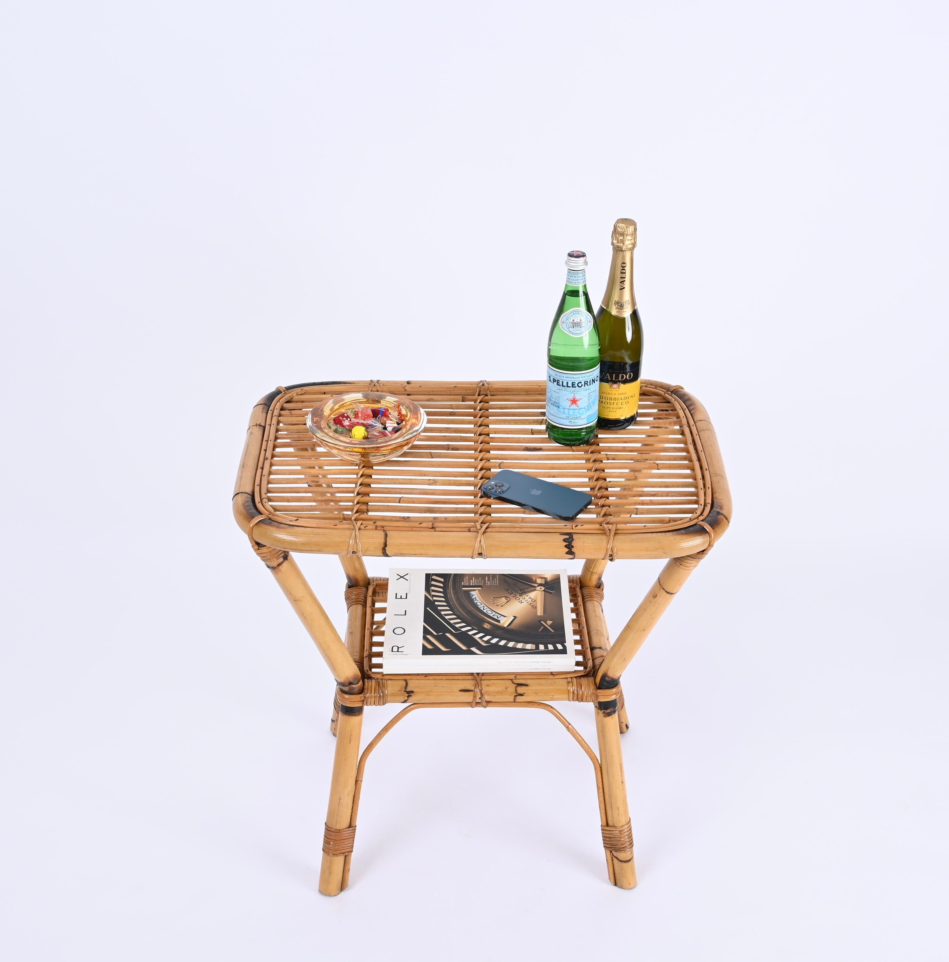 Stunning midcentury Italian coffee or side table in rattan, bamboo and wicker. This unique piece was produced in Italy during the 1960s.

This two-tier side table is fully hand-crafted with perfect proportions. The structure is made in sturdy curved