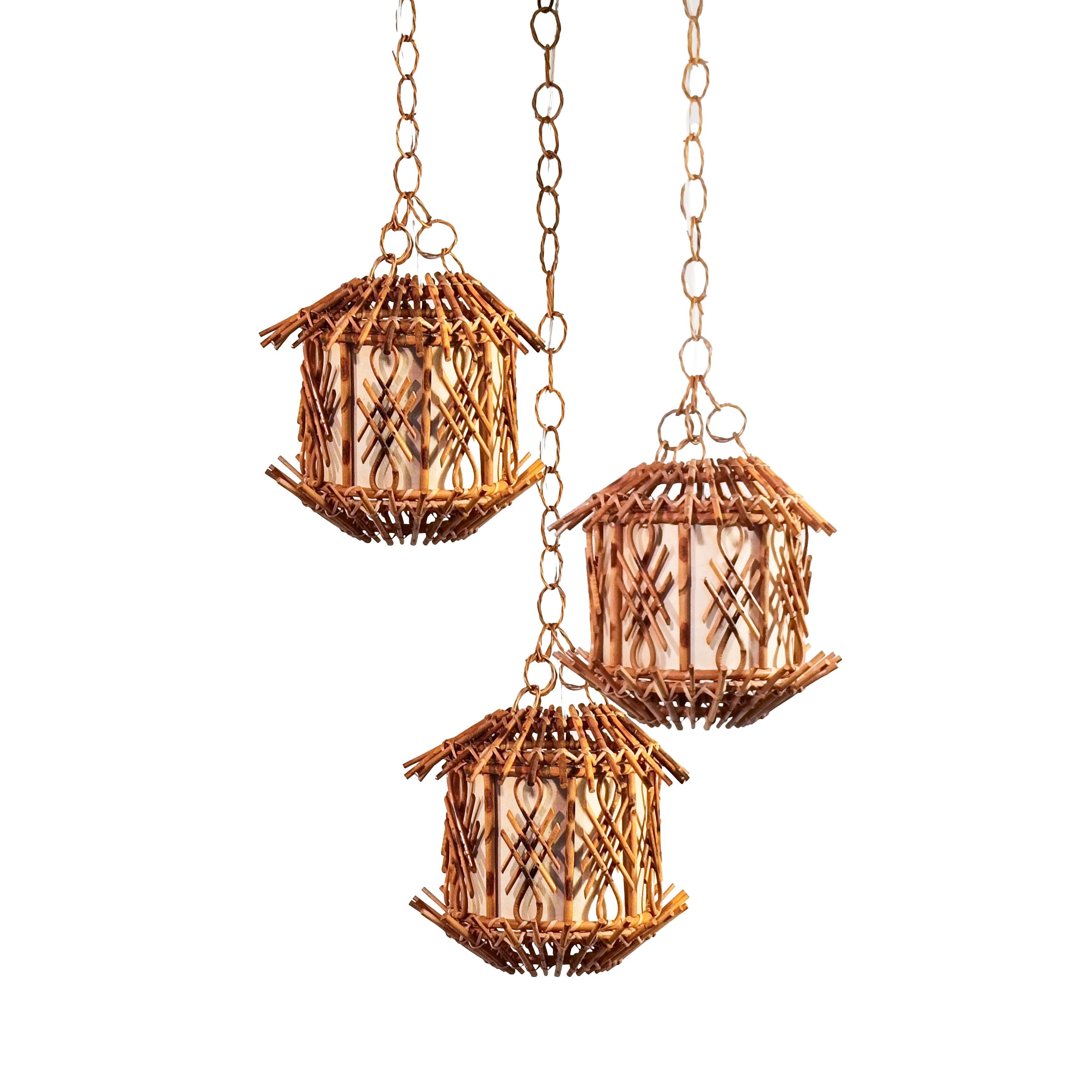 Ensemble de 3 lampes suspendues conçues par Louis Sognot, Italie, années 1960. Structure en canne et rotin séché au feu, avec un diffuseur en papier dur texturé beige. Style safari, Côte d'Azur et tiki, très populaire dans les années 60 et 70.
Pour