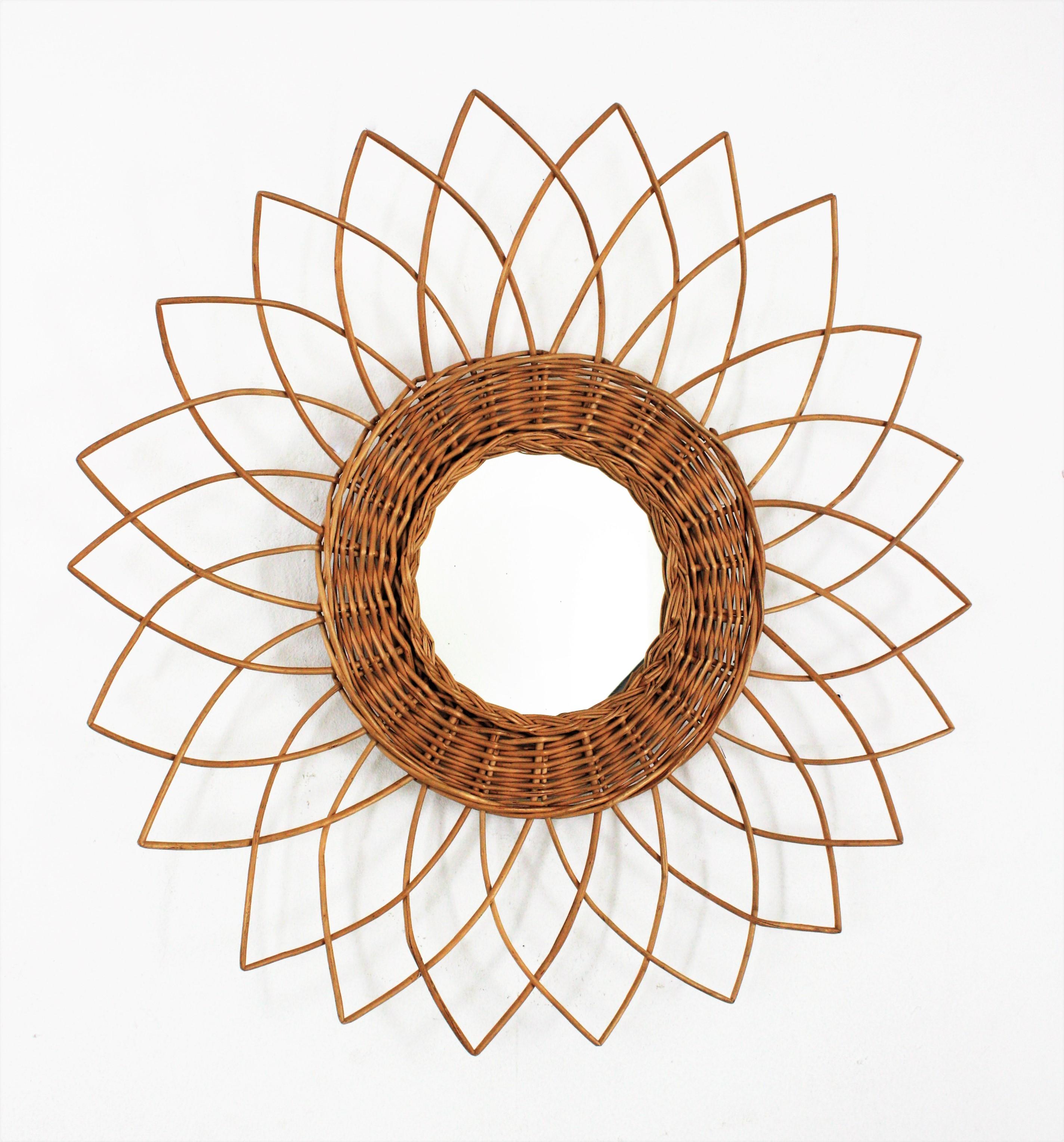 French Riviera Sunburst Starburst Mirror in Rattan, 1960s
Handcrafted starburst / sunburst / flower mirror with rattan frame, France, 1960s.
This eye-catching mediterranean sunburst mirror was handcrafted in France at the sixties and It has all the