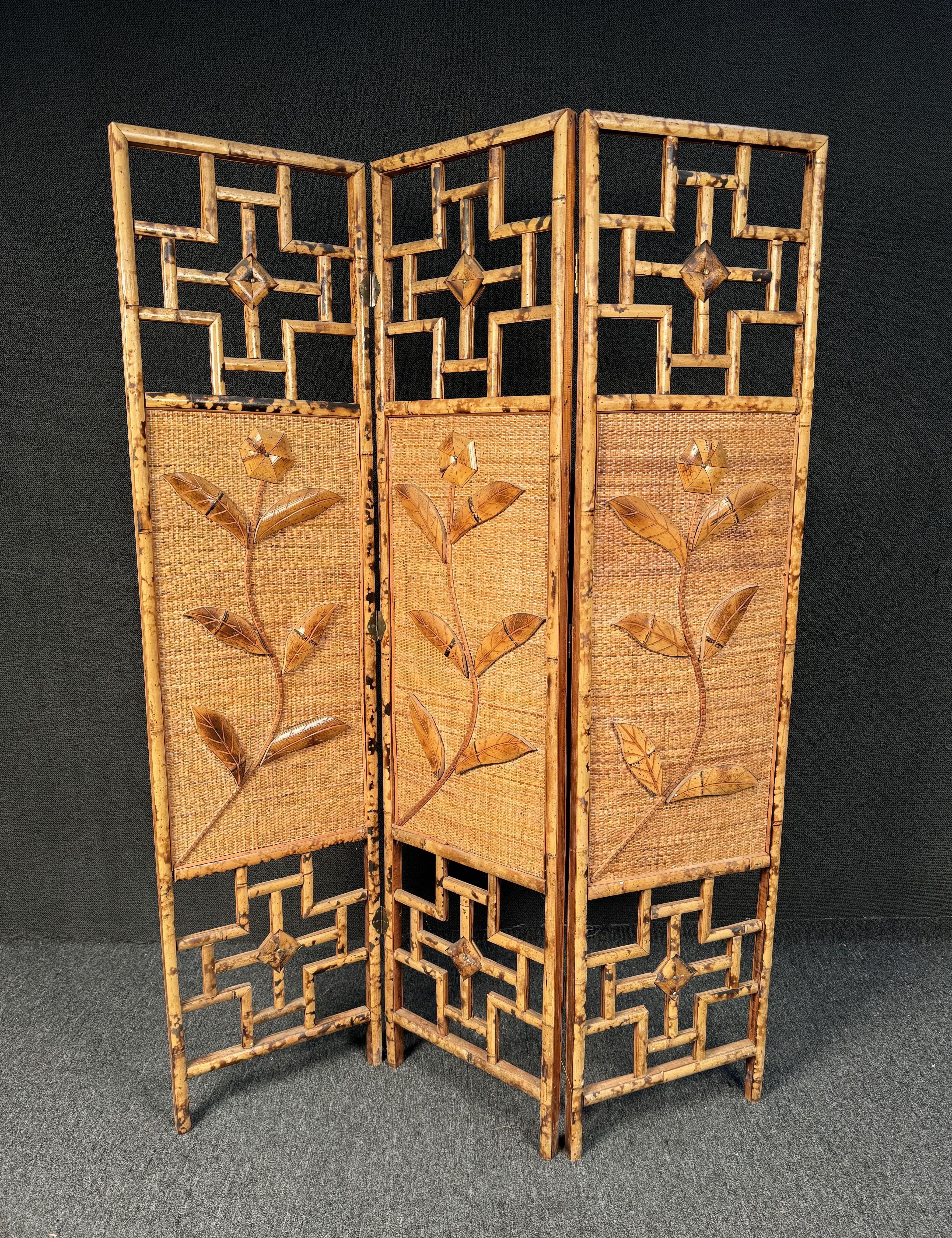 1970's French Rivera 3 paneled rattan and bamboo screen/room divider. Featuring flower motifs on front and back on center of panels. Please confirm location with seller (NY or NJ)
