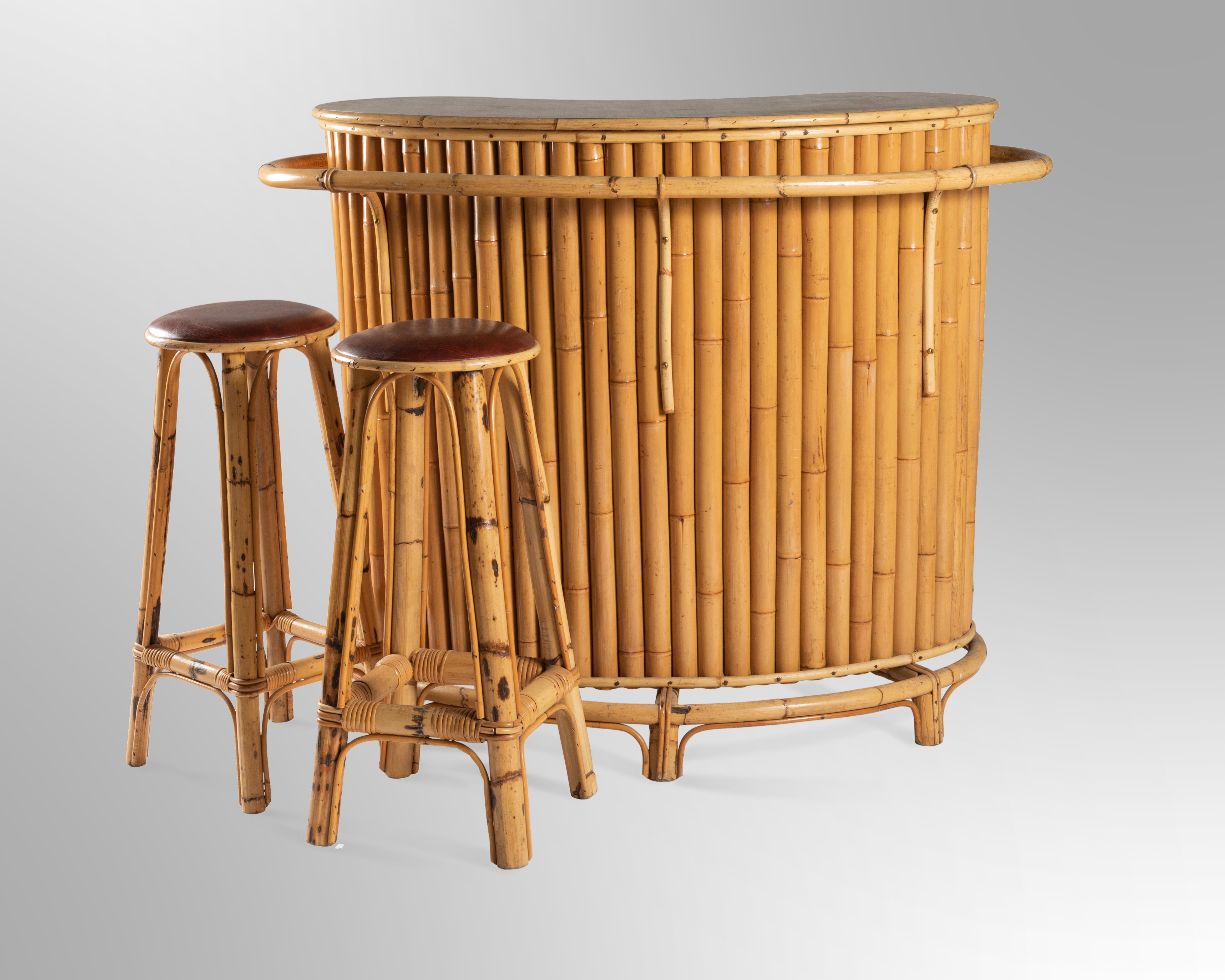 French Riviera vintage bar and pair of stools in bamboo. The bar top is in faux wood. Made in the South of France in the 1950s.

Dimensions:

Bar
H - 116cm
L- 130cm
P - 115cm

Stools (2)
H - 73cm (seat diameter - 32cm)
L - 35cm
P -