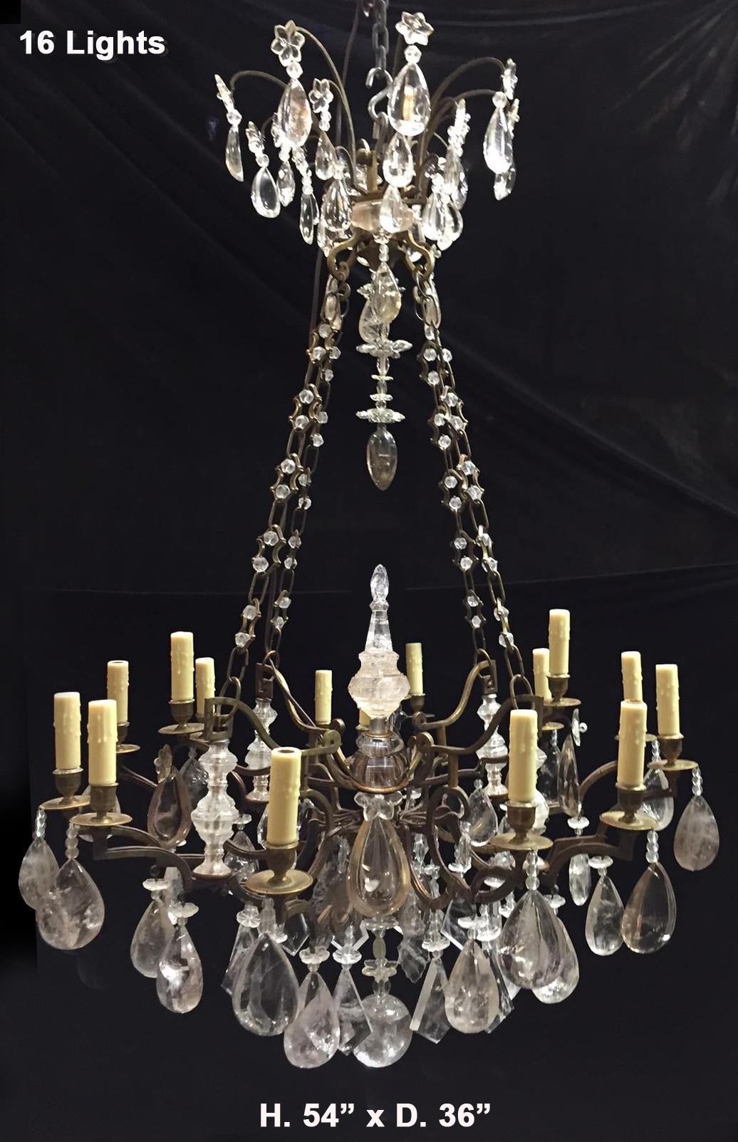 Impressive 19th century French hand-carved and hand-polished rock crystal and smokey rock crystal bronze two-tier sixteen-light chandelier with fabulous rock crystal spike in the center.
Beautifully finished bronze frame with sixteen curved arms