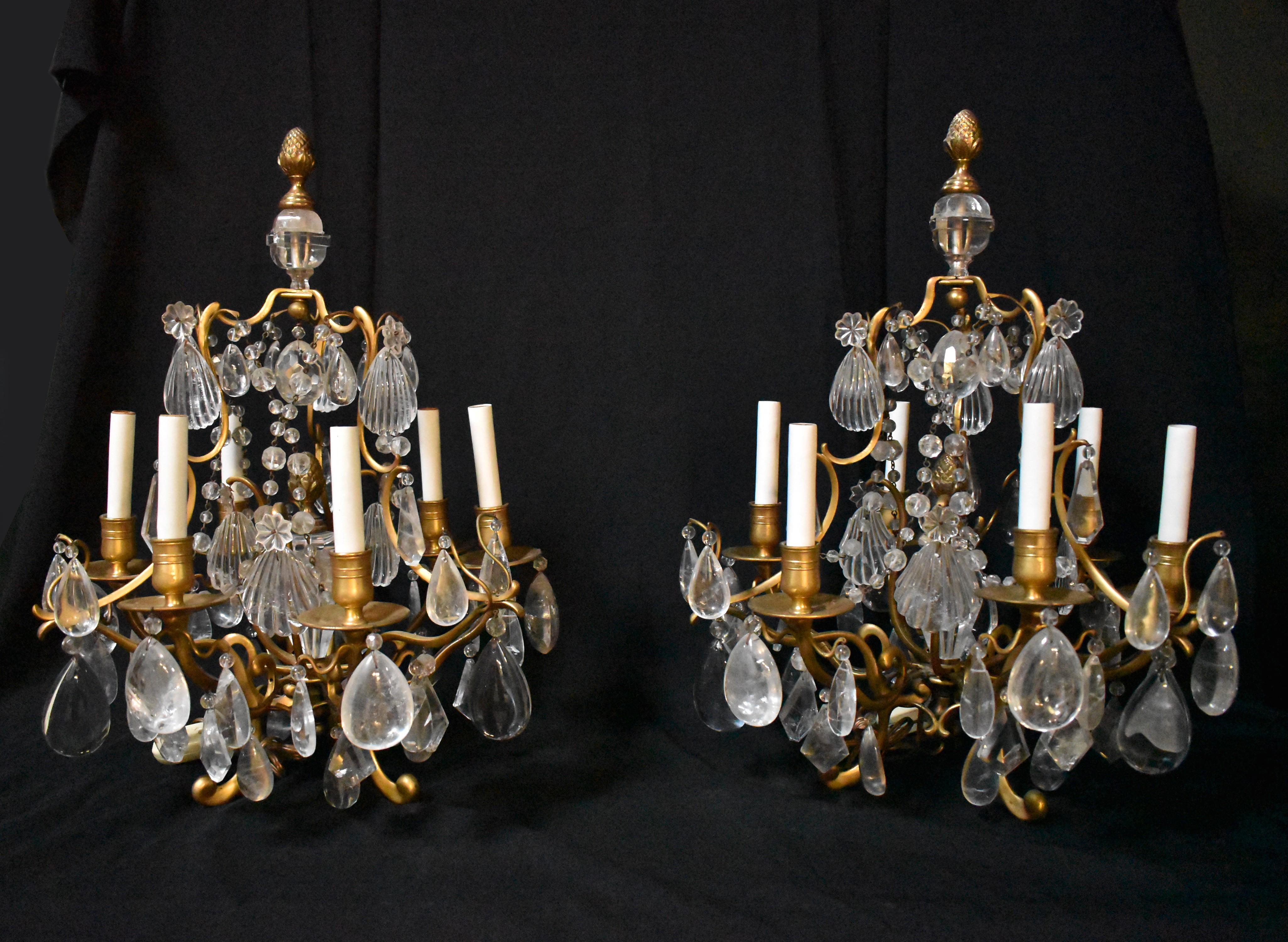 Impressive French 19 century Louis XV style hand carved Rock Crystal and gilt bronze six light girandoles.
Each girandole is surmounted with a gilt bronze pineapple finial, over a fancy shaped Rock Crystal prism, all supported by four gilt bronze