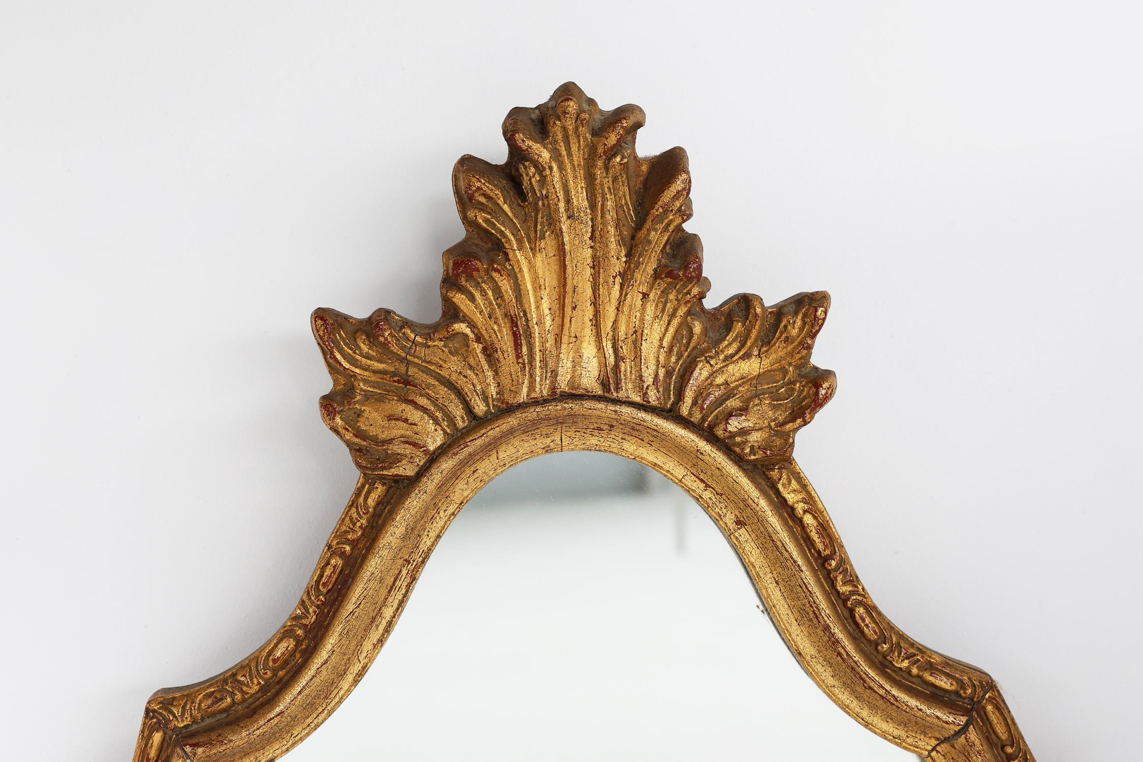France / 1950 / Mirror / wood / Baroque / Mid-century / Vintage

21th Century vintage mirror in rococo-baroque style. Crafted in gilted wood with stylish carvings and a flame as crest.

A real eye catcher, this mirror with its gilded frame that