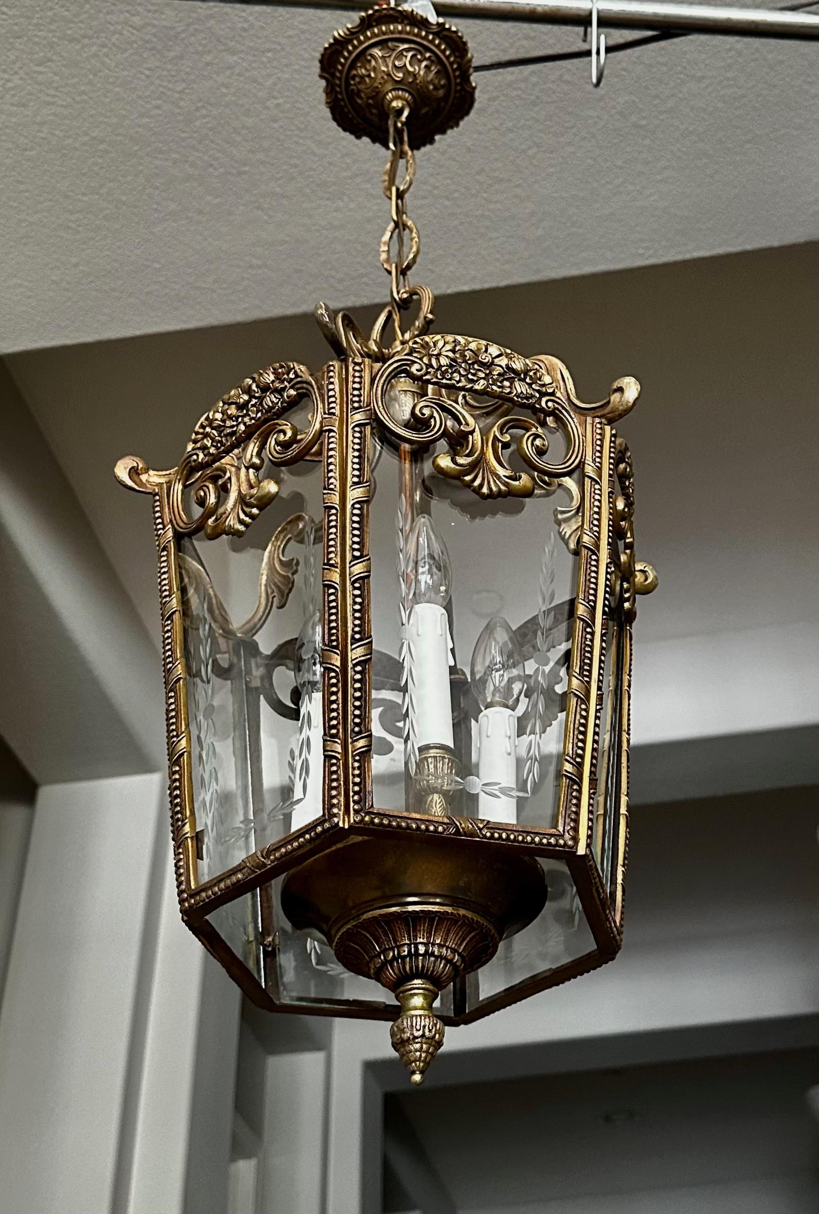 French 1940's rococo style brass and etched glass lantern hall light pendant.  Well constructed with nice overall detailing throughout. Uses 3 candelabra size bulbs. Height of fixture 24