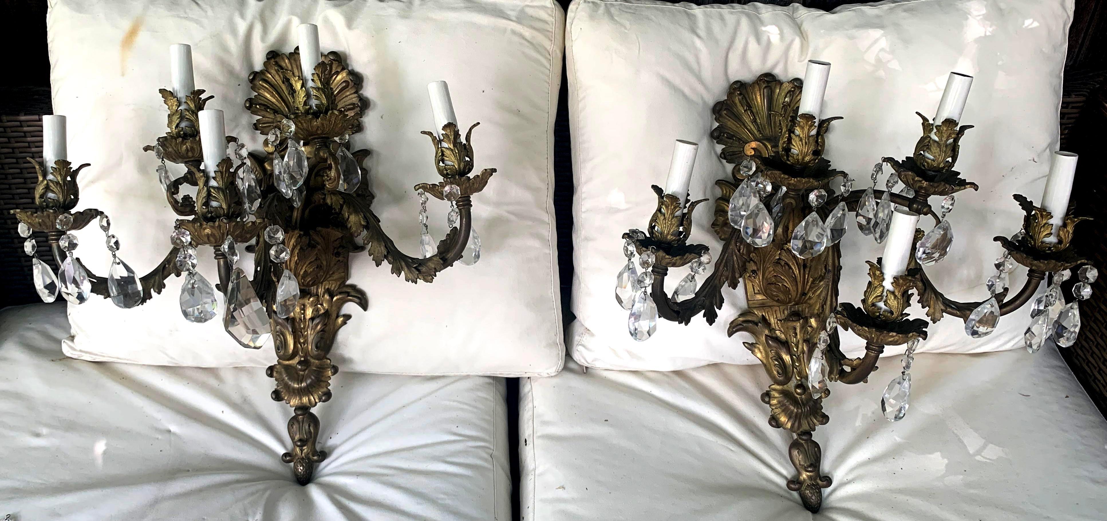 Gorgeous Pair of French Rococo Gilt Bronze and Crystal Sconces, Circa 1780. This detailed sconce features acanthus motif throughout, even at the base of each candle. The heavy cast bronze detail highlights the intricacies of each leaf. Beautifully