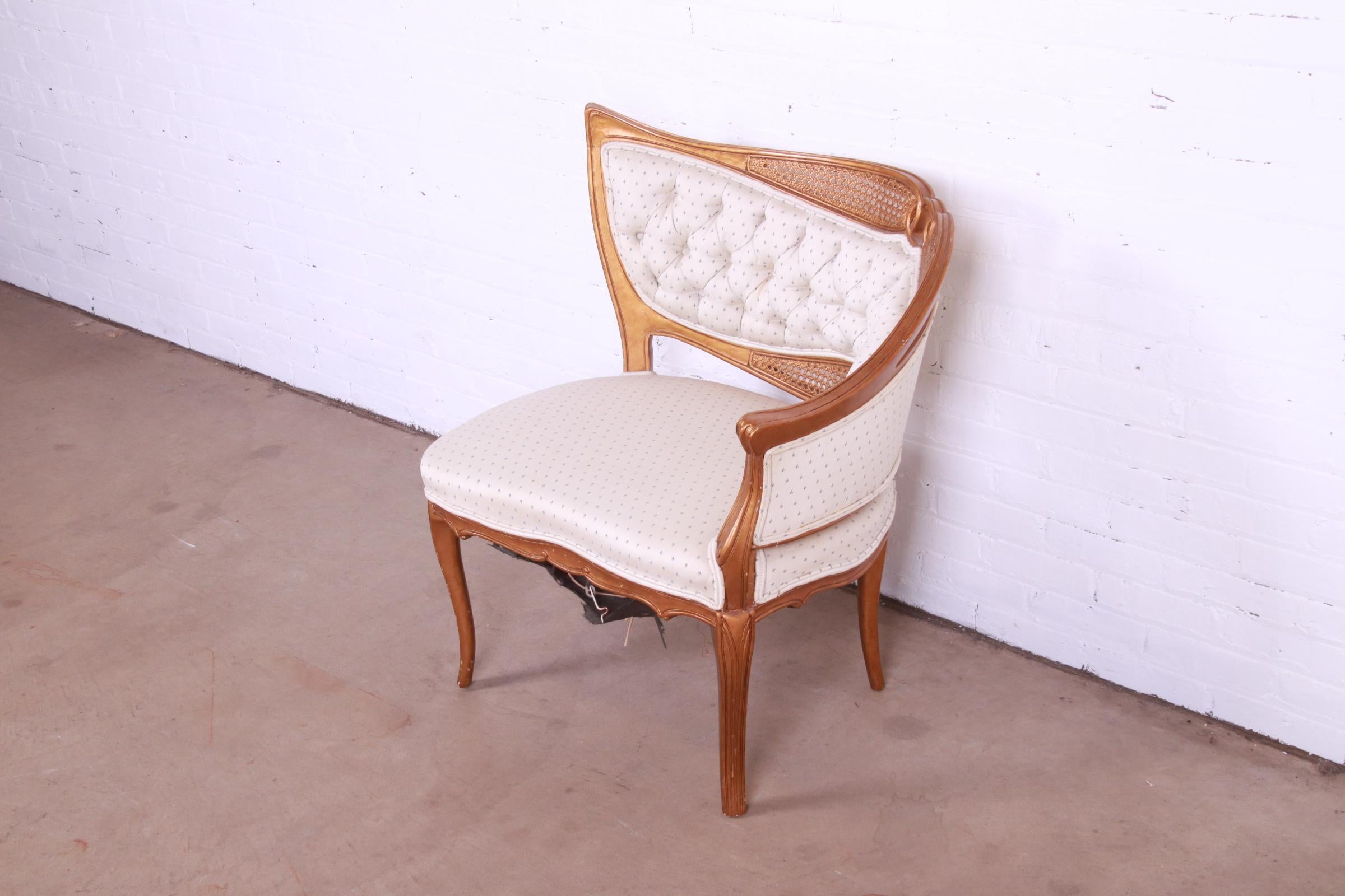 A gorgeous French Rococo Louis XV style gilded fireside club chair or lounge chair

Attributed to Grosfeld House

Mid-20th Century

Giltwood and caning, with upholstered seat and back.

Measures: 31