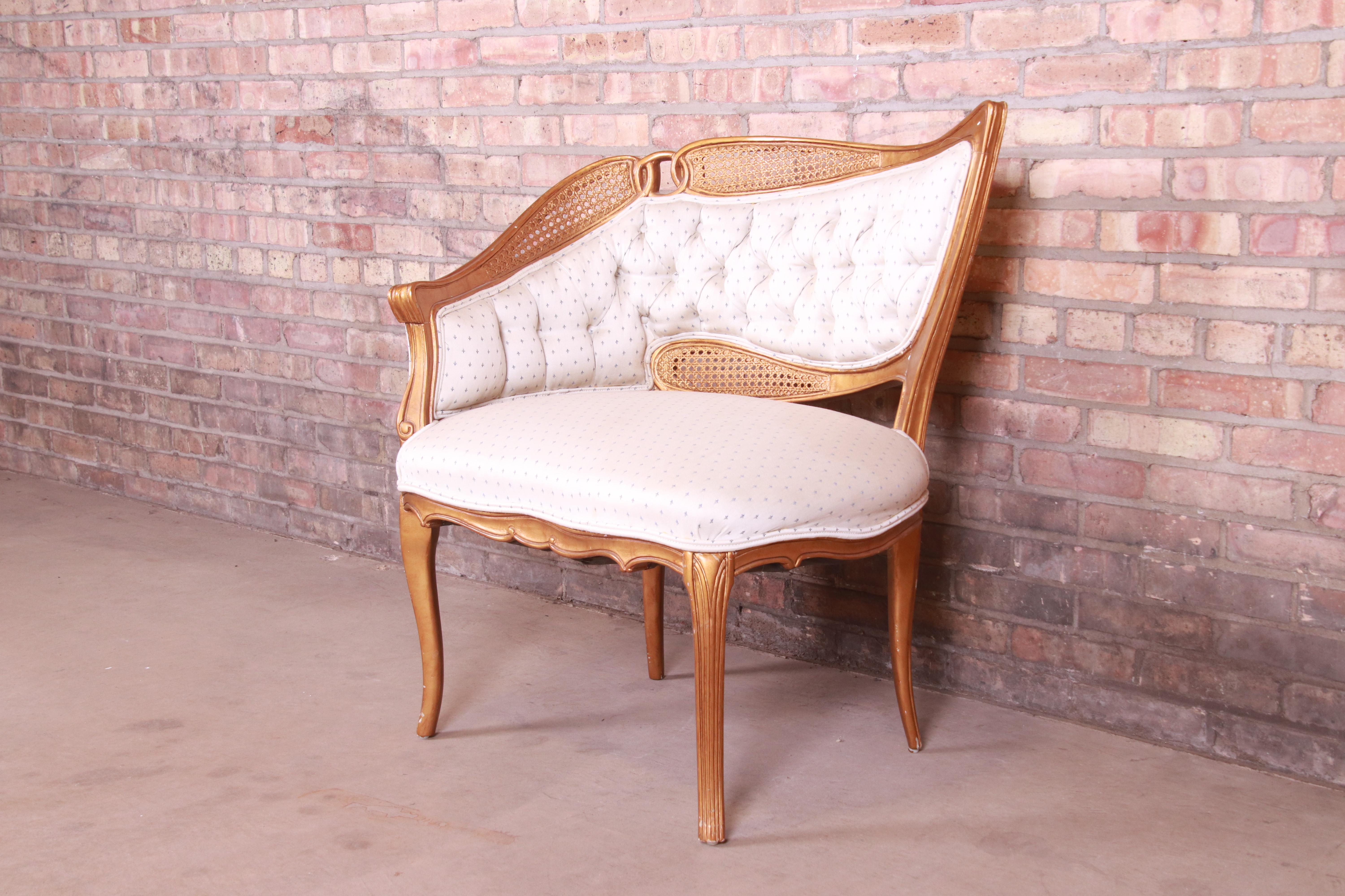 American French Rococo Louis XV Giltwood and Cane Upholstered Fireside Chair