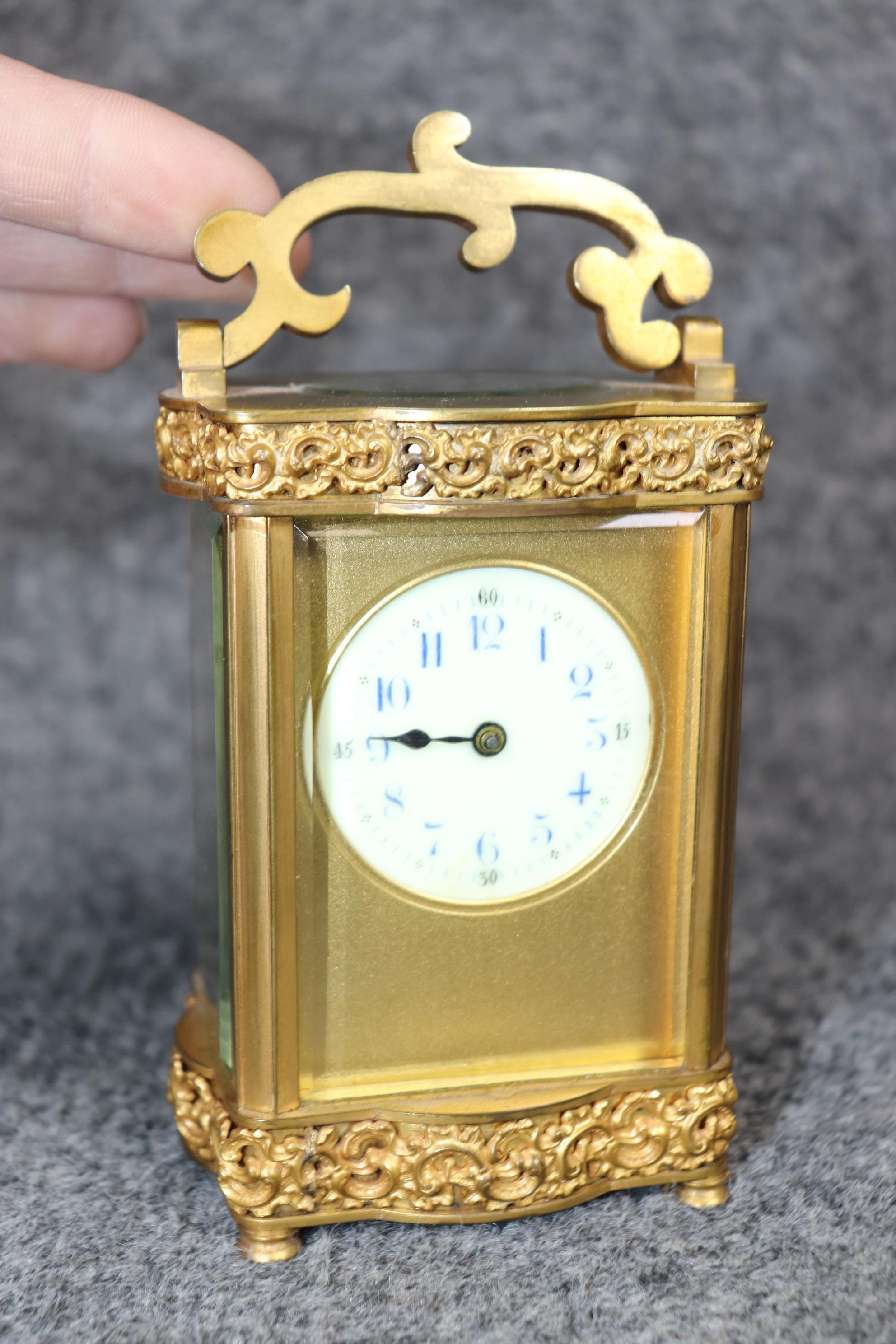 Dimensions - H: 6 1/4in W: 3 1/4in D: 2 1/2in 

This antique early 20th century French Louis XV style bronze ormolu carriage clock is made of the highest quality!  This will be perfect for your any office, entryway, living room, dining room,