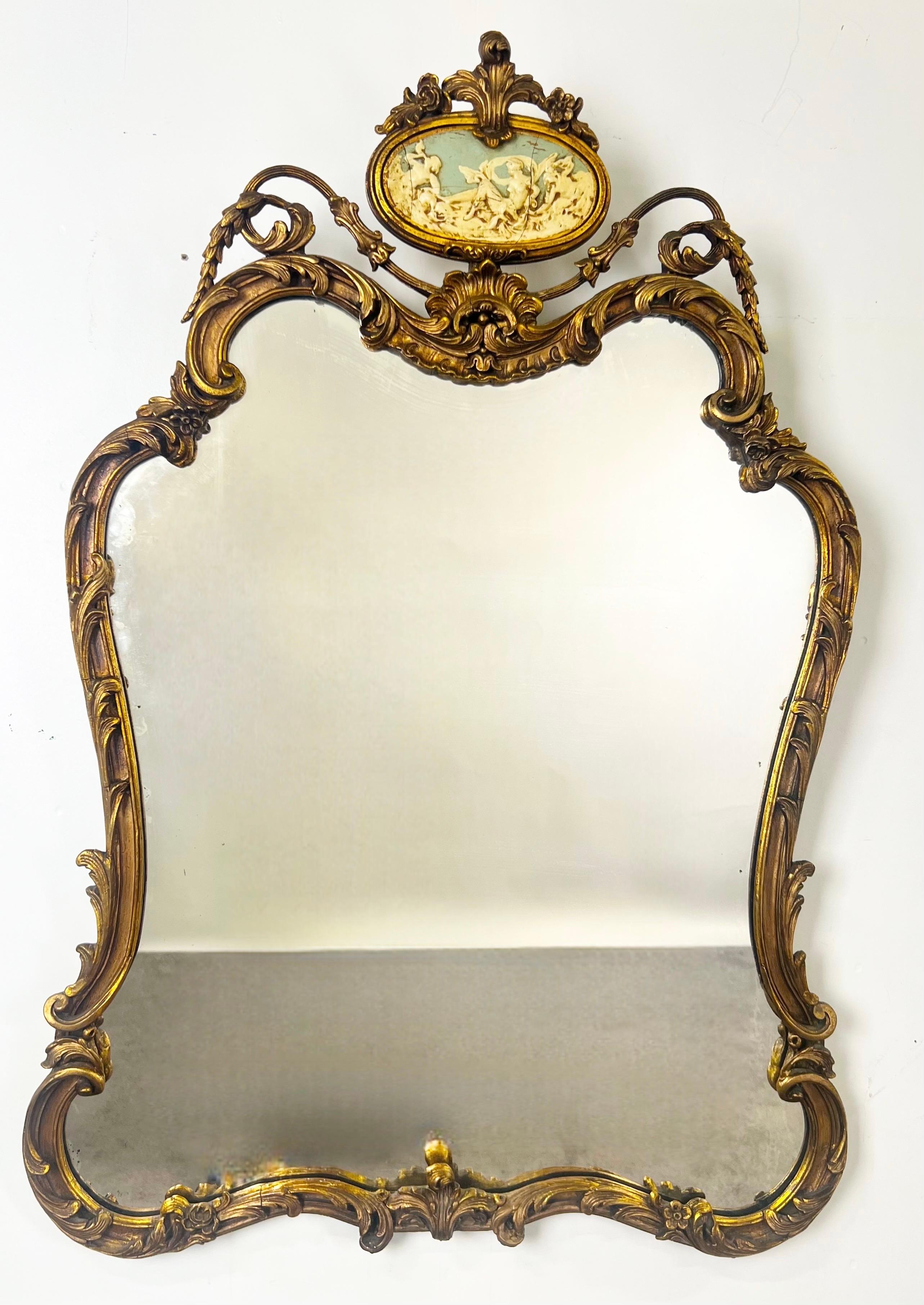 Antique French Rococo Louis XV Style Giltwood Mantel Mirror : 

An exquisite 19th century French Rococo mirror in the Louis XV style, richly decorated with flowing curves and ornate foliate scrollwork. The giltwood frame showcases the elegance and