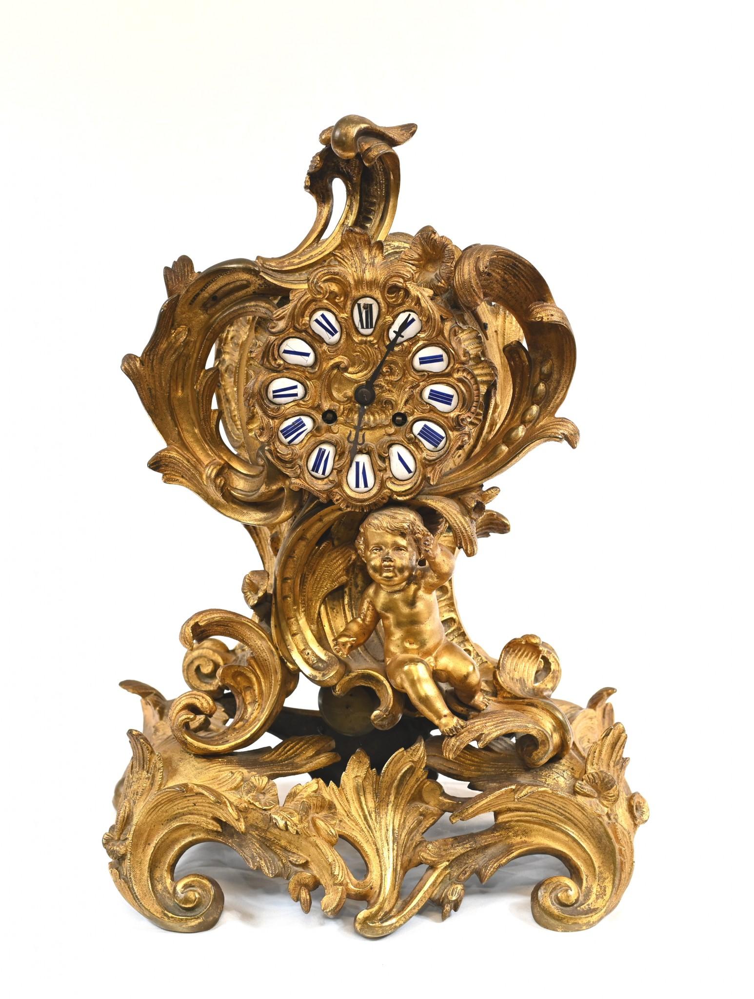 An unusual French ormolu rococo style mantle clock.
The hours on the clock face are represented in Roman numerals in enamel.
Glorious patina to the gilt, look at details like the cherub.
Great collectable clock
Purchased from a dealer on Rue de
