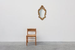 French Rococo or Baroque style facet-cut crest mirror in gilded carved wood