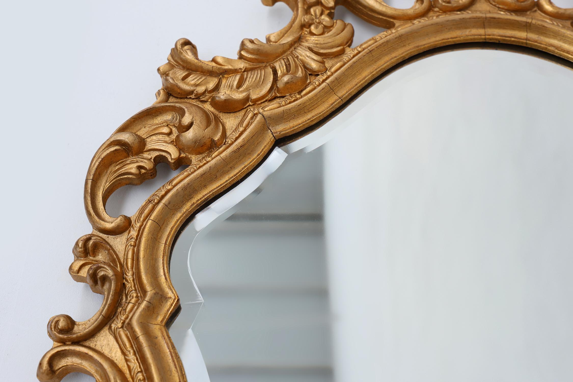 Mid-20th Century French Rococo or Baroque style facet-cut crest mirror in gilded carved wood For Sale