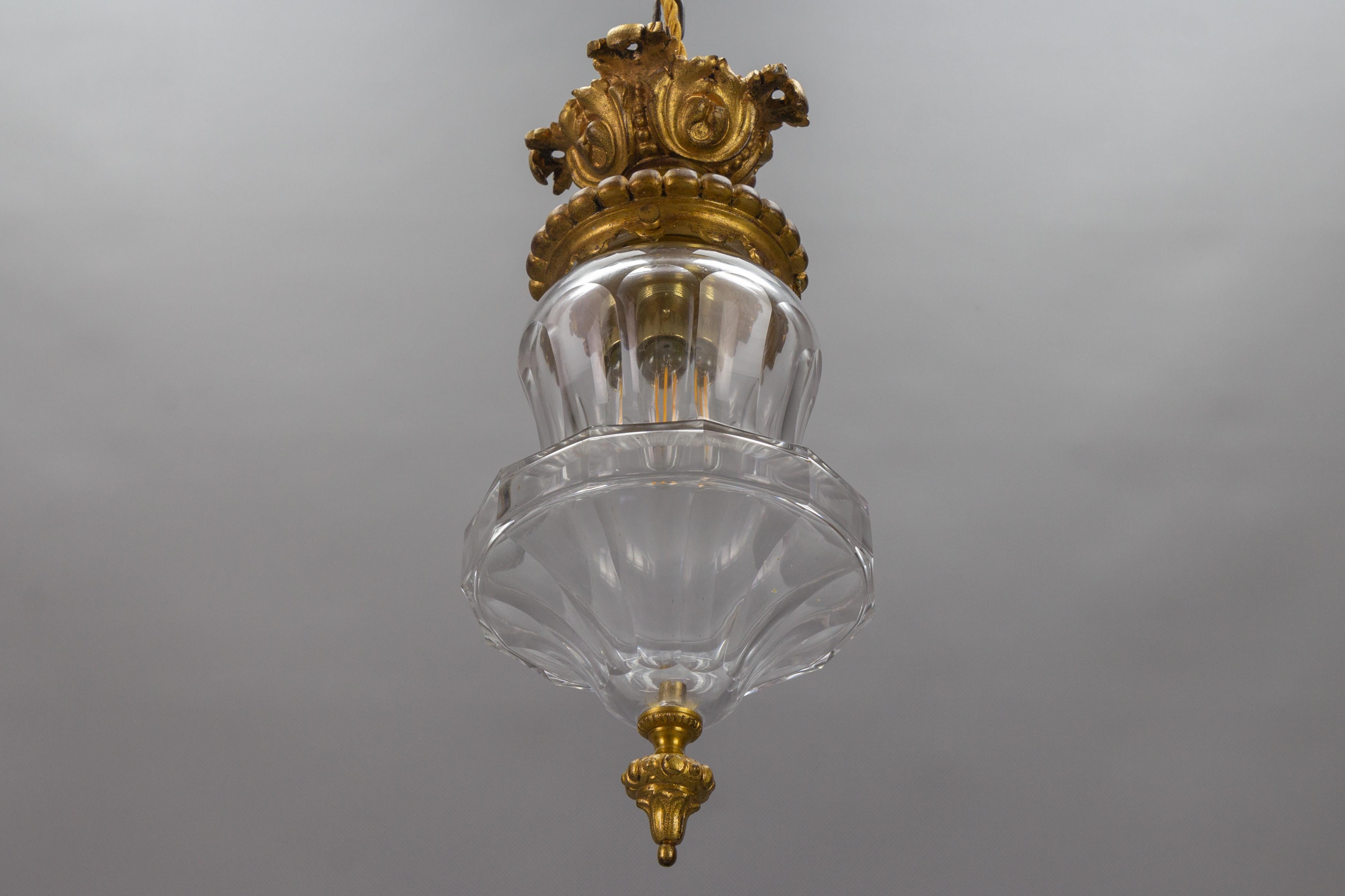 French Rococo style bronze and crystal glass flush mount from circa 1900.
This adorable flush mount or ceiling light features an ornate bronze fixture and a beautifully shaped crystal glass lampshade with a bronze finial.
One new socket for E27