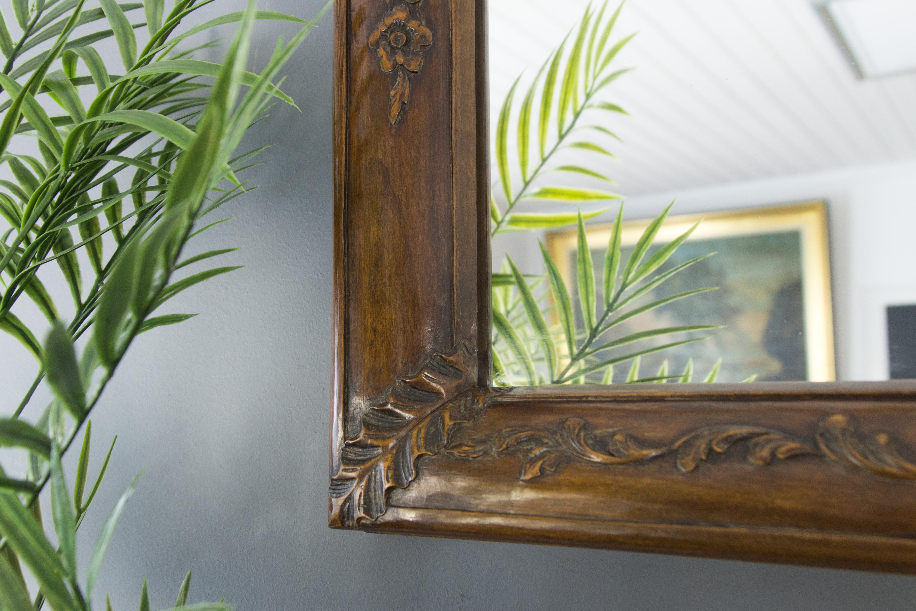 This beautiful Rococo style wall mirror features a walnut frame decorated with finely carved leaves, floral and scroll details, France, circa 1920s.
In very good condition, some wear signs consistent with age and use, please see the pictures.
 