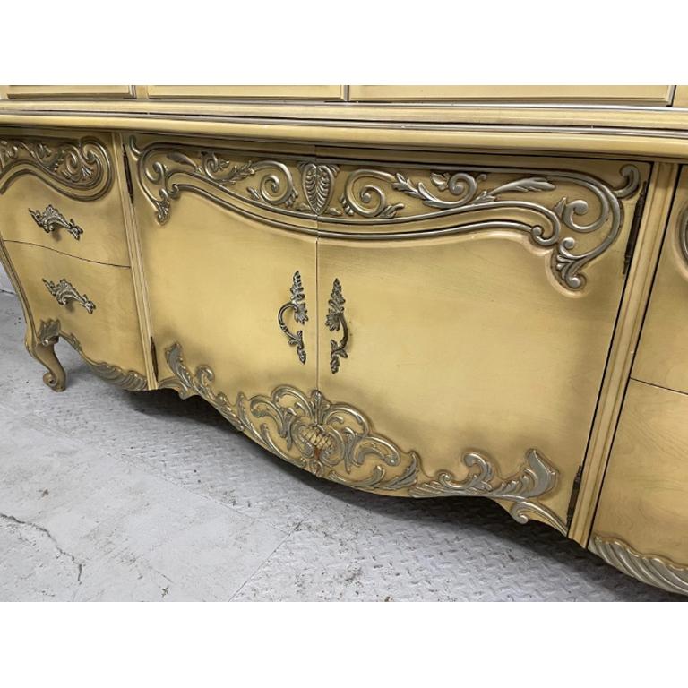 Large lighted dining cabinet by Romweber in ornate French Rococo style features lighted interior and onlays of cartouche design elements. Good condition with imperfections consistent with age, see photos for condition details. Professional