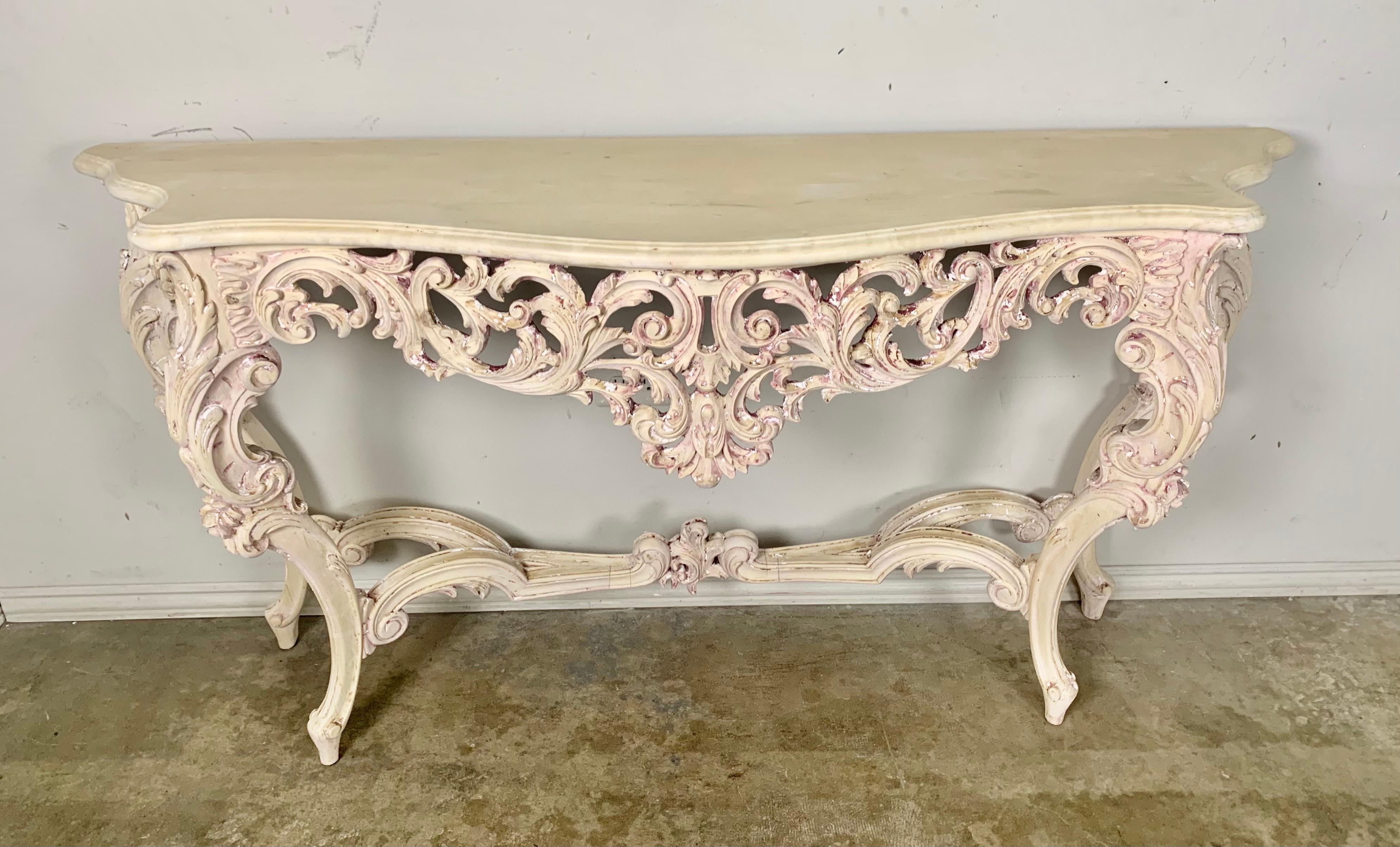 French carved wood Rococo style console with simple wood top. The console stands on four cabriole legs with a stretcher that meets at a center finial.