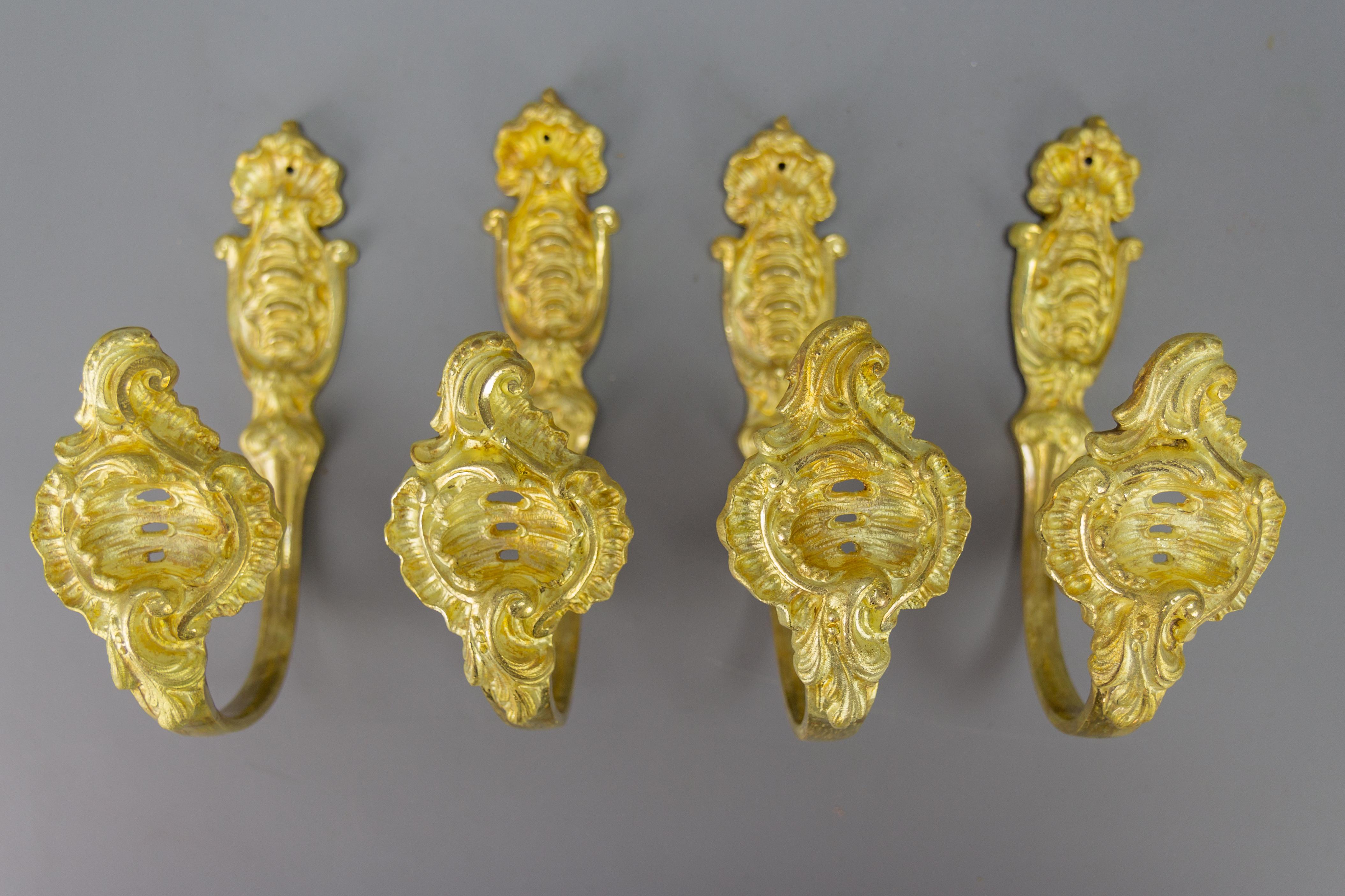 Antique French Rococo style gilt bronze curtain tiebacks or curtain holders, set of four.
A beautiful and impressive set of four Rococo or Louis XV-style gilt bronze curtain holders or supports, or tiebacks. These splendid curtain supports are