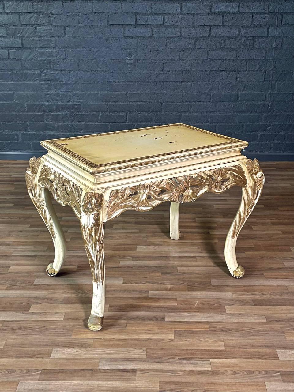 Condition: Original Vintage Condition 
Materials: Carved Wood w/ Gilt & Painted Finish
Style: French Rococo

This French Rococo style center table from the 1950s showcases elaborate carved woodwork adorned with a richly painted and gilt finish. The
