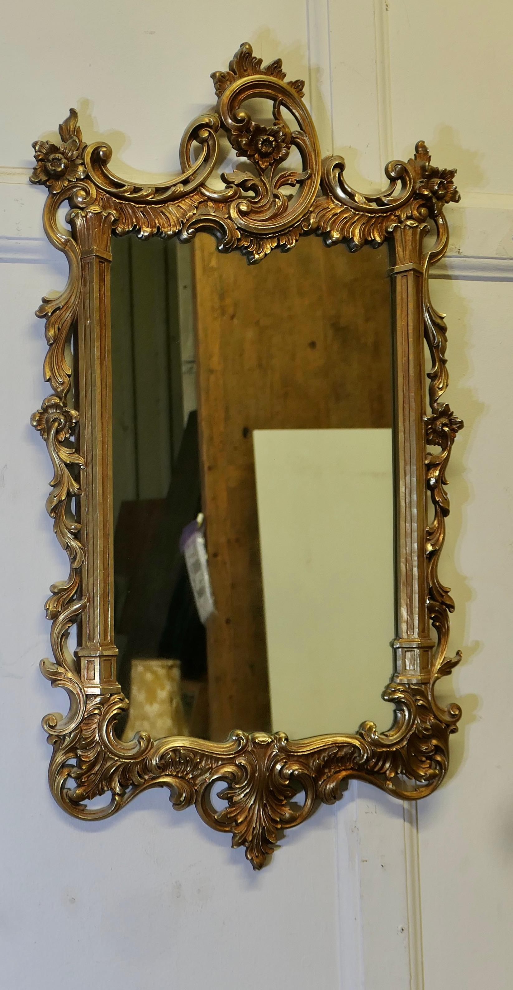 French Rococo Style Gilt Wall Mirror 

This is a beautifully Decorative Rococo Style Gold Frame Mirror it is a very pretty shape with heavy gilded deep moulded frame
The frame is intricately shaped in 3D with Scrolls and Curling Leaves, the gilt