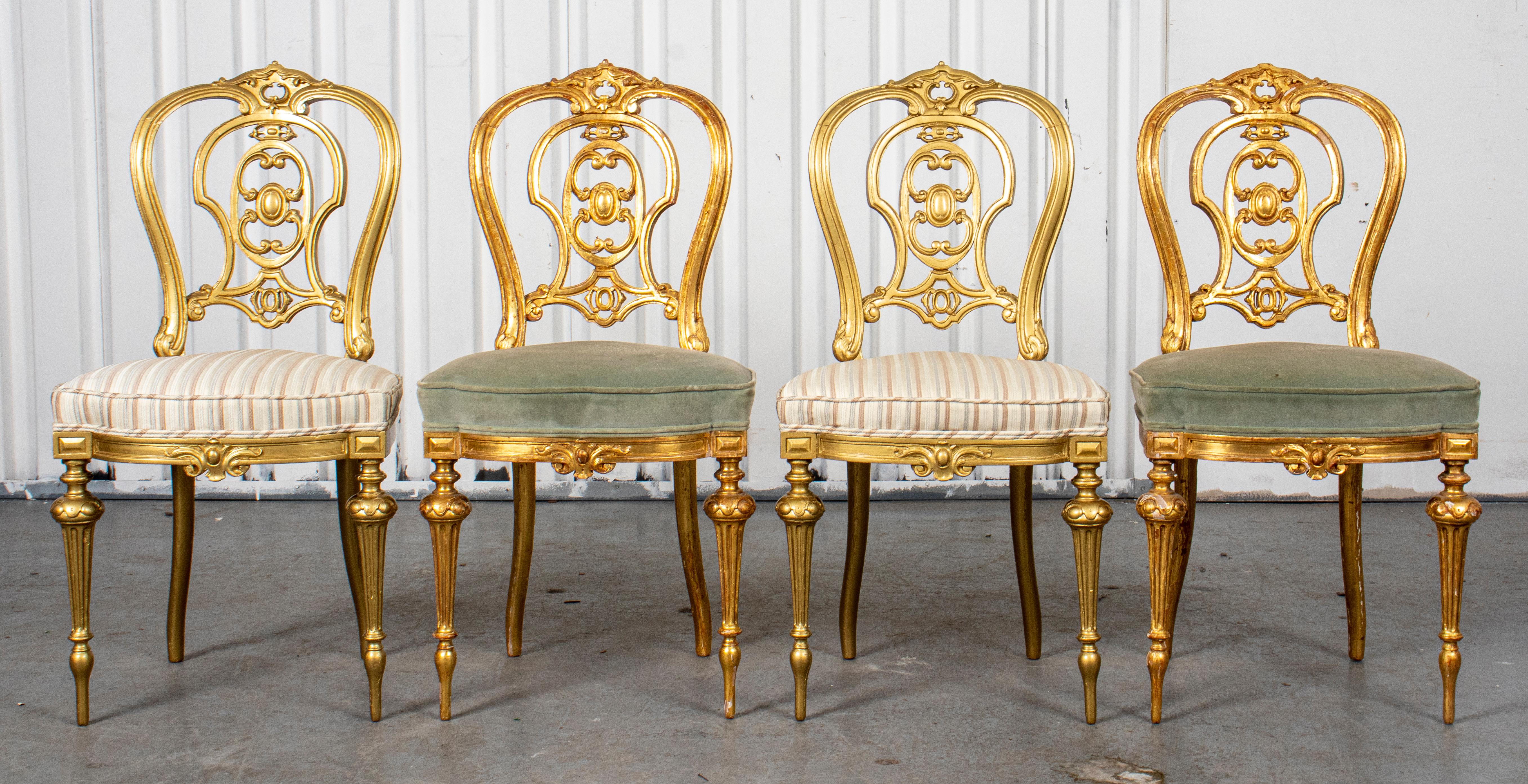 Four French Rococo style giltwood side chairs, mid 19th century, with exuberant back splats and tapered legs. 34