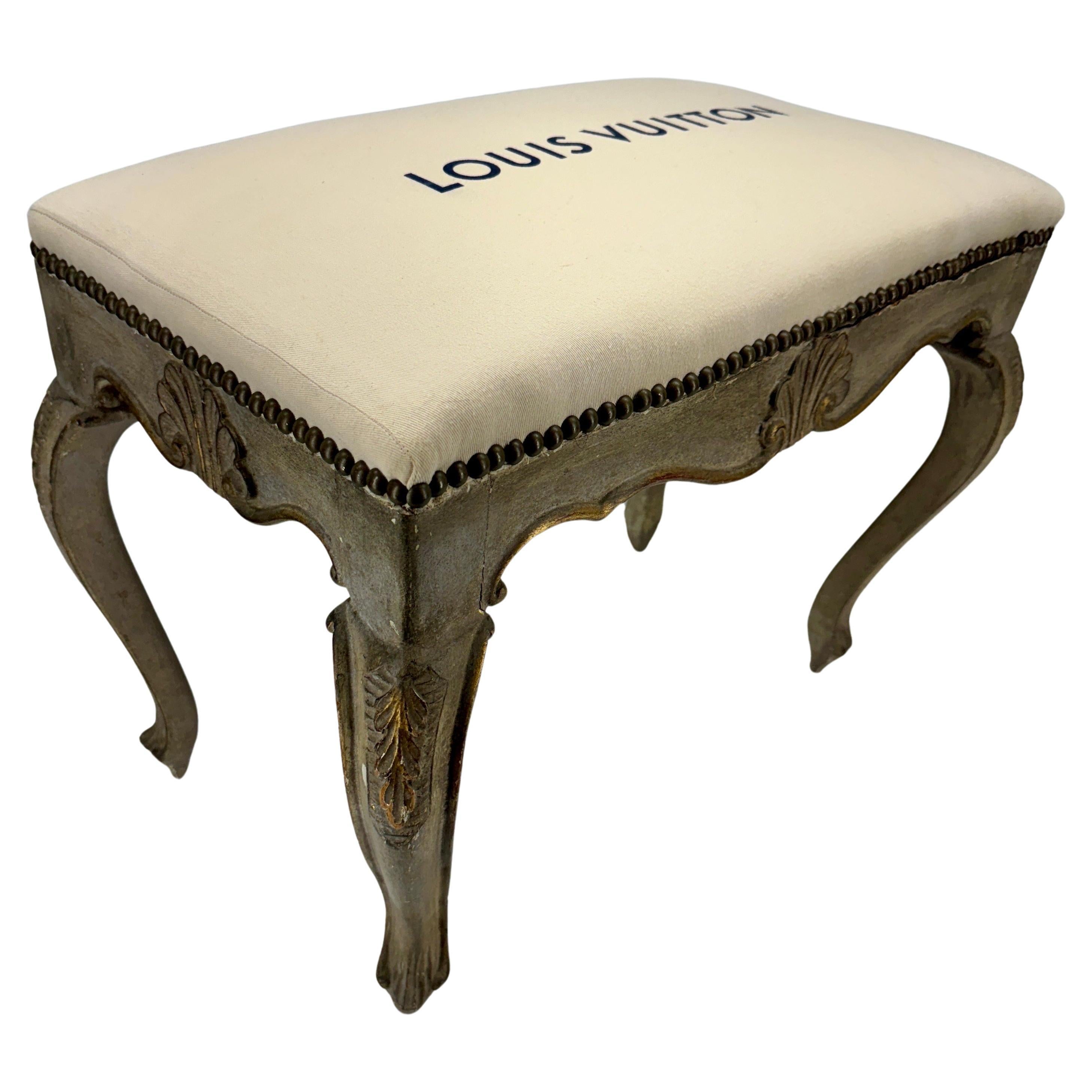 French Rococo style Louis Vuitton upholstered bench with carved rocaille woodwork and Louis Vuitton printed on the upholstered seat. Certainly a statement piece in any formal or informal home living room or bedroom.