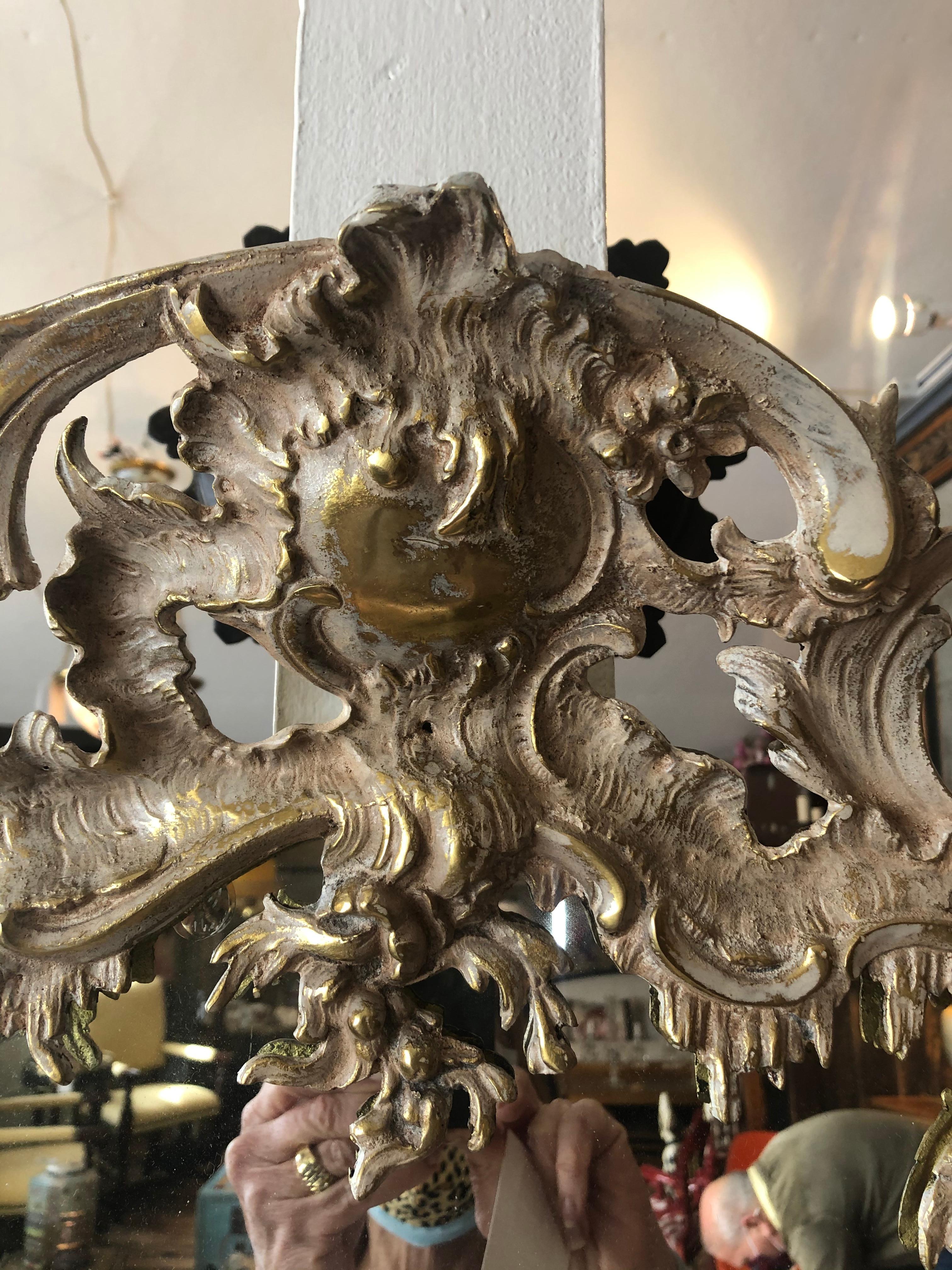 French Rococo Style Relief Cast Brass and Antiqued Cartouche Shaped Wall Mirror In Good Condition In Hopewell, NJ