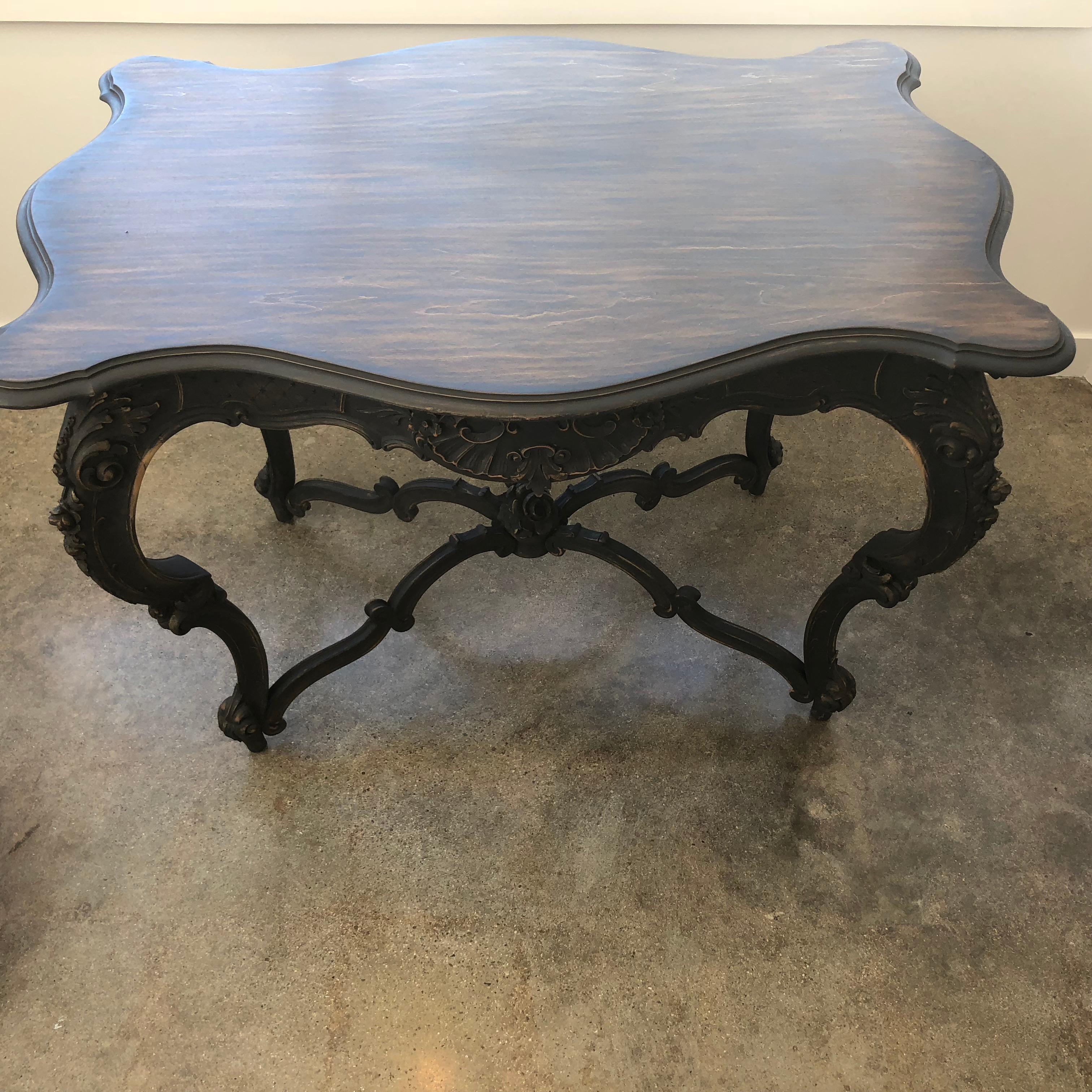Gorgeous Rococo table, circa 1880. It has detailed elegant carving. The finish in black/deep brown has further enhanced the wonderful grain on top. The piece has real presence.