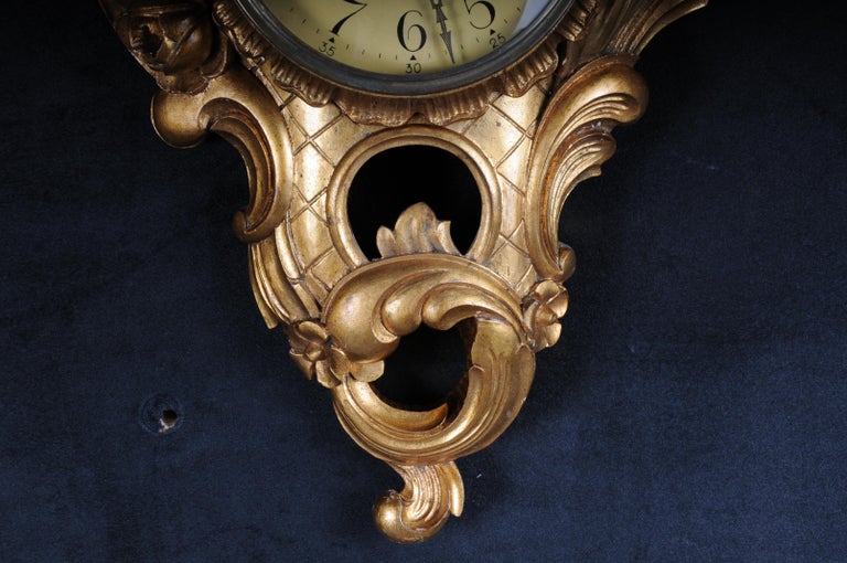 Solid wood hand-carved with rich rococo elements. Roman dial. Glazed.
Clockwork should be checked for accuracy.

(K-57).