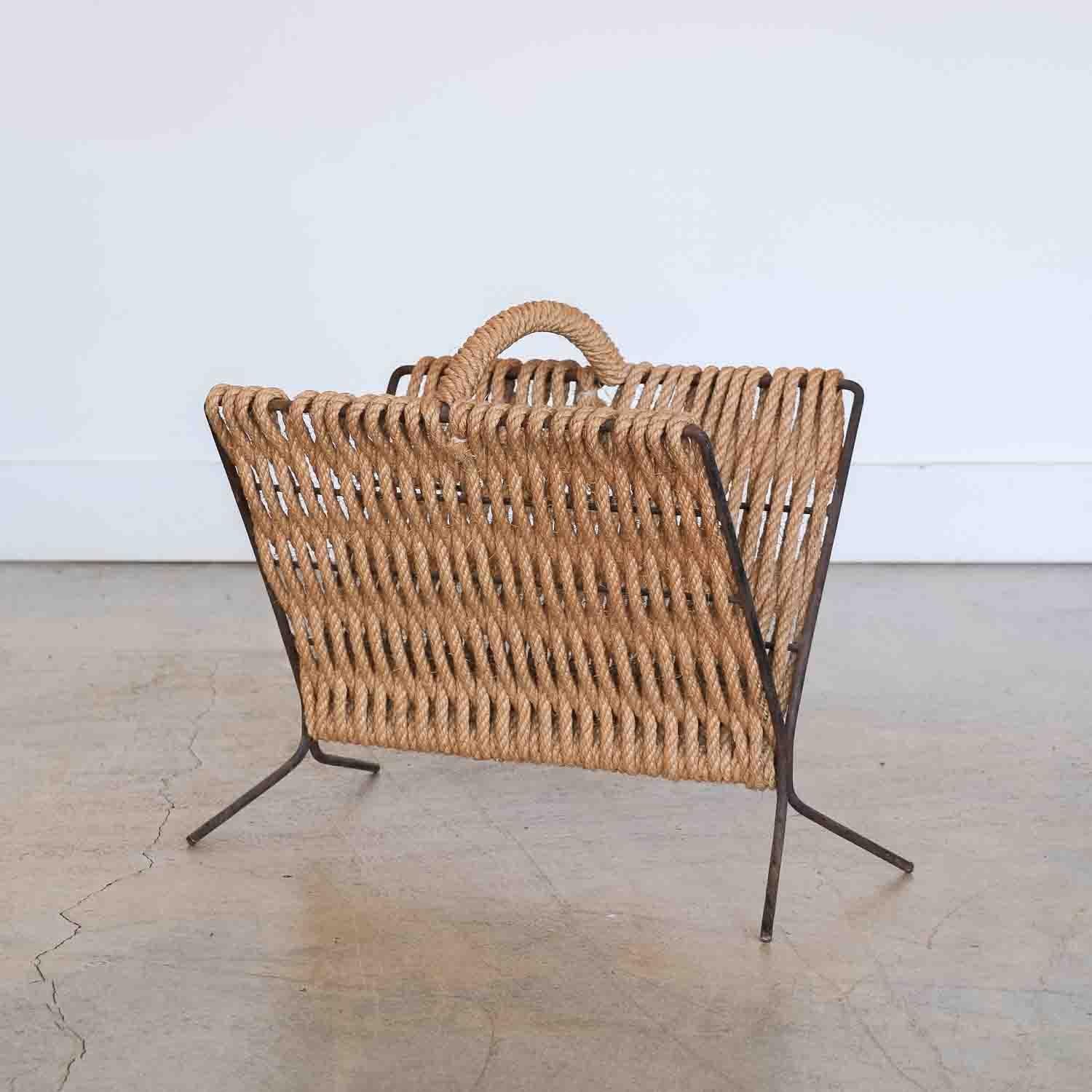 Beautiful rope and iron magazine rack from France, 1950's. Original woven rope shows nice age and patina on iron. Unique storage piece. 