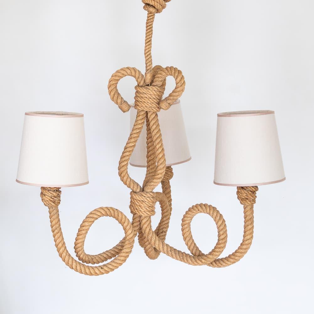 Incredible rope chandelier by French designers Adrien Audoux and Freda Minet. Beautiful three looped arms and stem in wrapped rope. New tapered linen shades with tan trim detail and newly re-wired. Original rope shows great patina and age. Takes