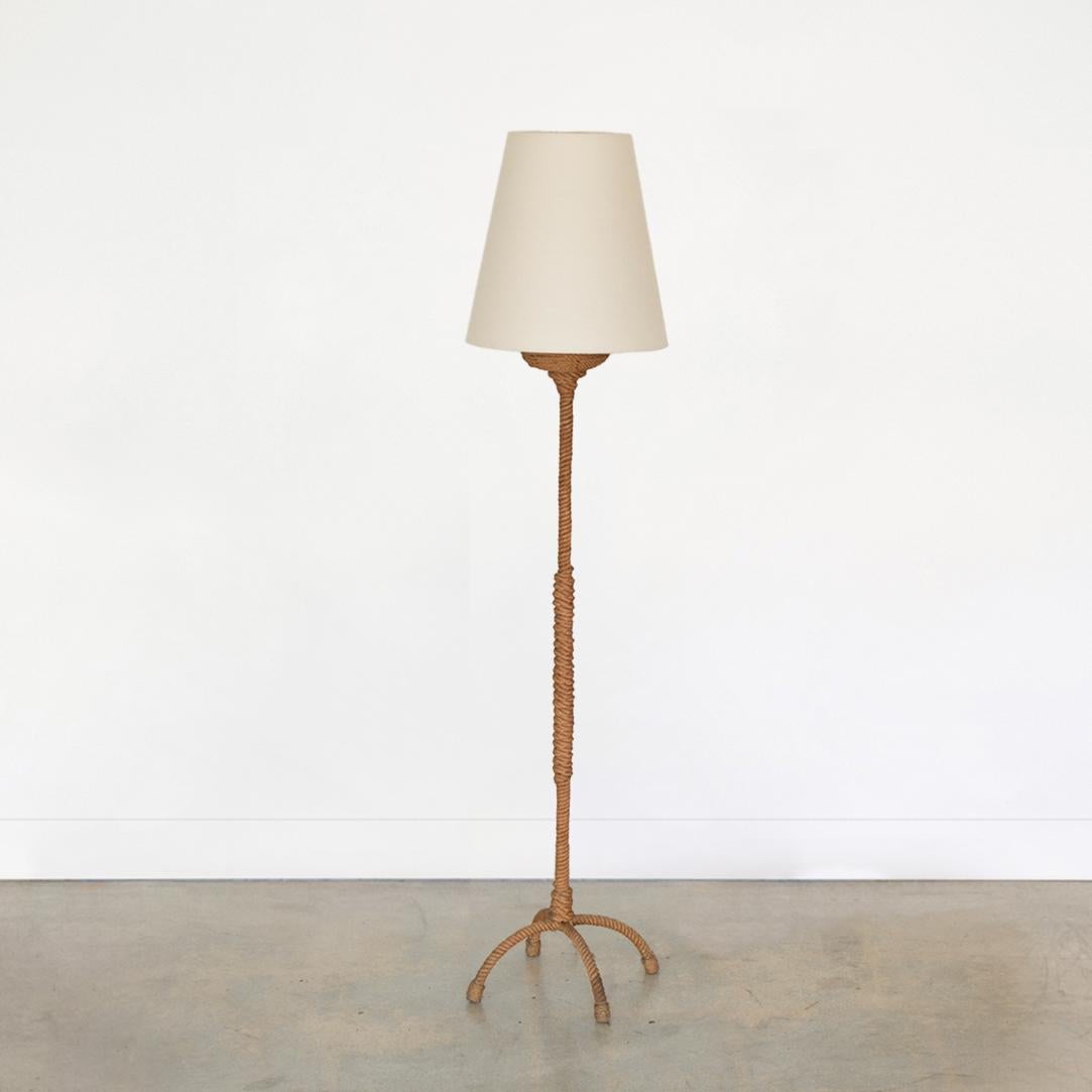 Incredible rope floor lamp by French designers Adrien Aduoux and Freda Minet. Four arched legs and slender stem with new linen shade. Rope is original with signs of age and wear. Newly re-wired.