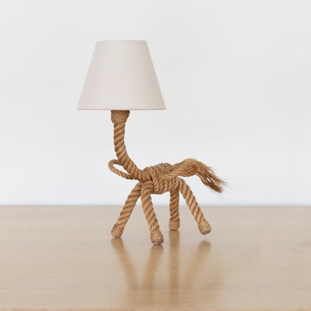 Whimsical small rope table lamp in the shape of a horse in the style of Adrien Audoux & Frida Minet, France, 1960s. Beautiful twisted rope body and tail on four rope legs. New petite tapered linen shade and newly rewired. Nice vintage condition