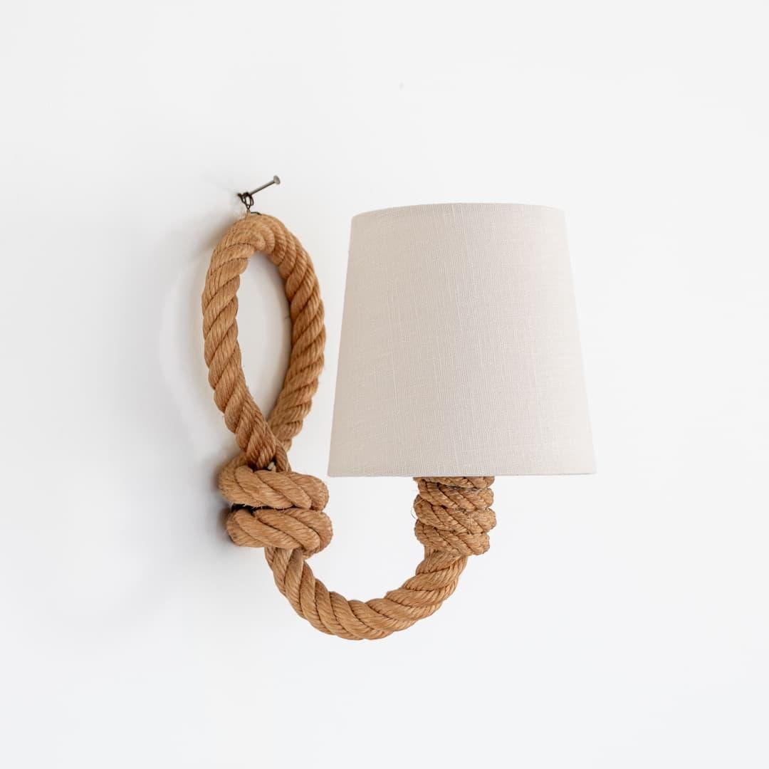 Unique vintage French rope sconce by French designers Adrien Audoux and Frida Minet. Thick twisted rope arm extending to hold single socket and shade. Large loop detail on back. Newly rewired with brown twisted cord, hand switch and plug. New linen