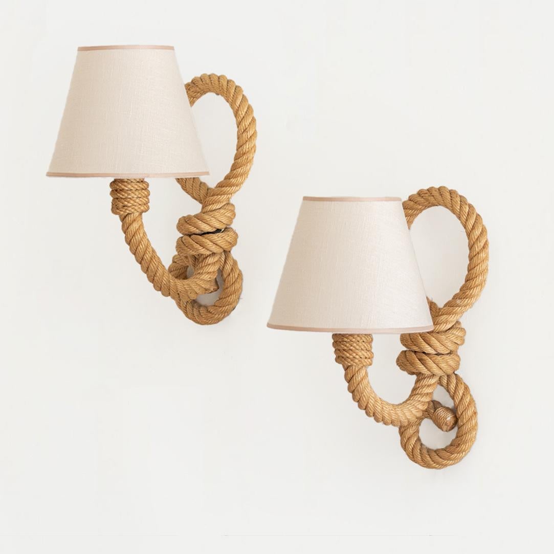 Vintage rope sconces by Audoux-Minet from France, 1950's. Brown twisted rope with curly rope detailing and curved neck holding a single socket on each. New creamy linen shade with tan trim. Newly re-wired with brown cloth twist cord, switch, and