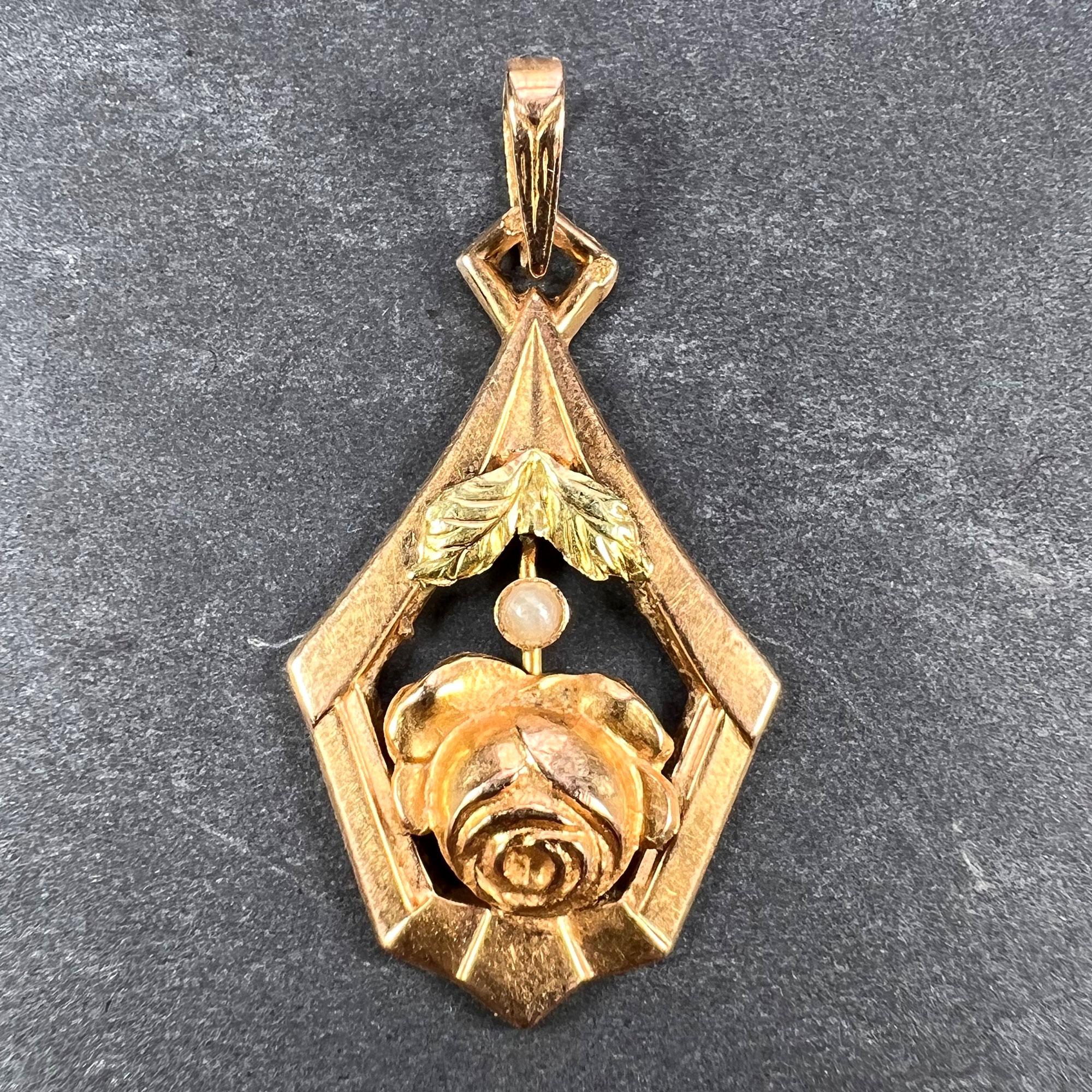 A French 18 karat (18K) yellow gold charm pendant designed as a rose within a frame set with a white seed pearl. Stamped with the eagle’s head mark for 18 karat gold and French manufacture, and an unknown maker’s mark.

Dimensions: 2.5 x 1.5 x 0.3