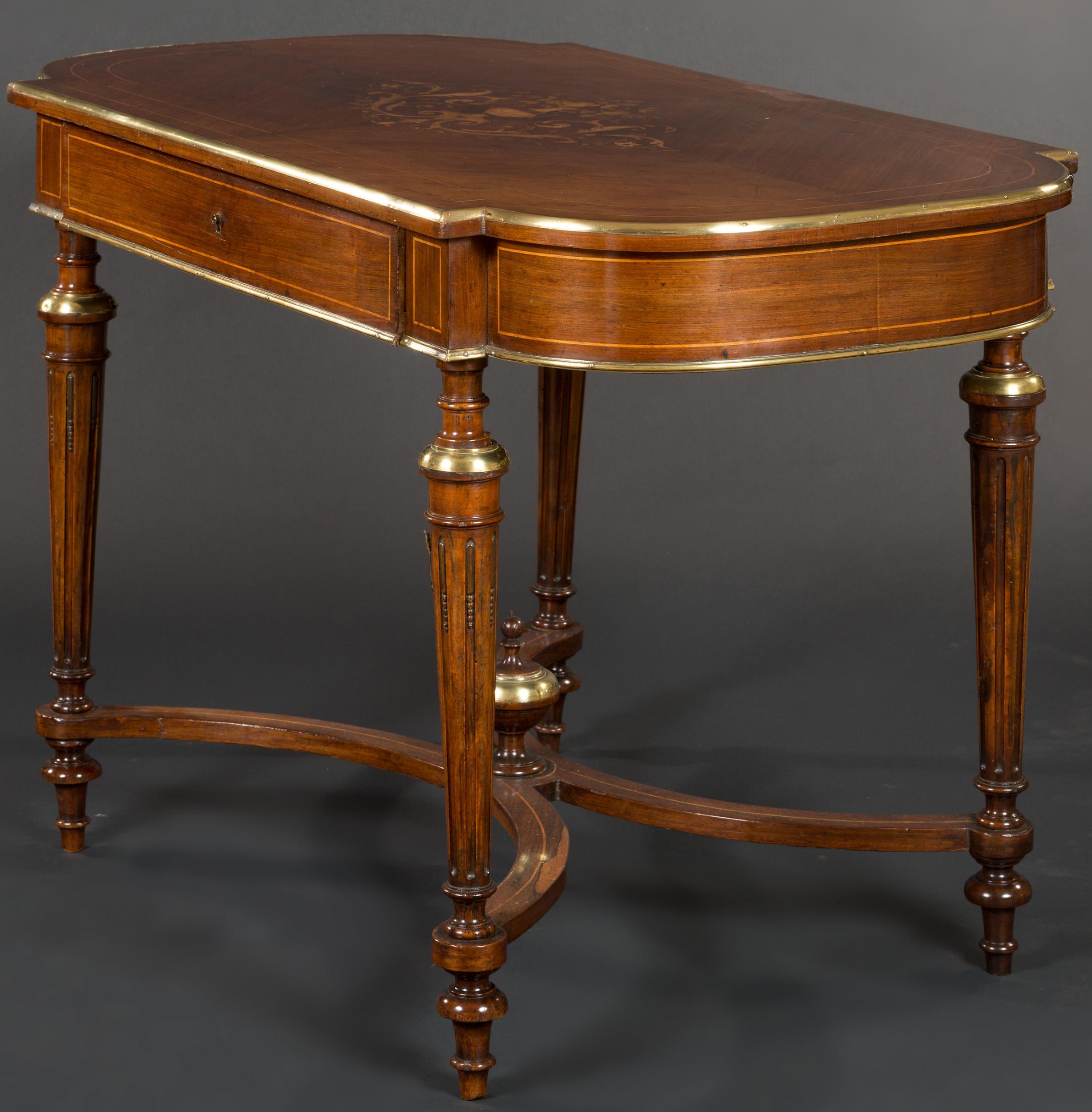 French rosewood and marquetry center table.

The table with brass mounts, inlaid stringing, fluted legs with shaped stretcher and frieze drawer, c1880.