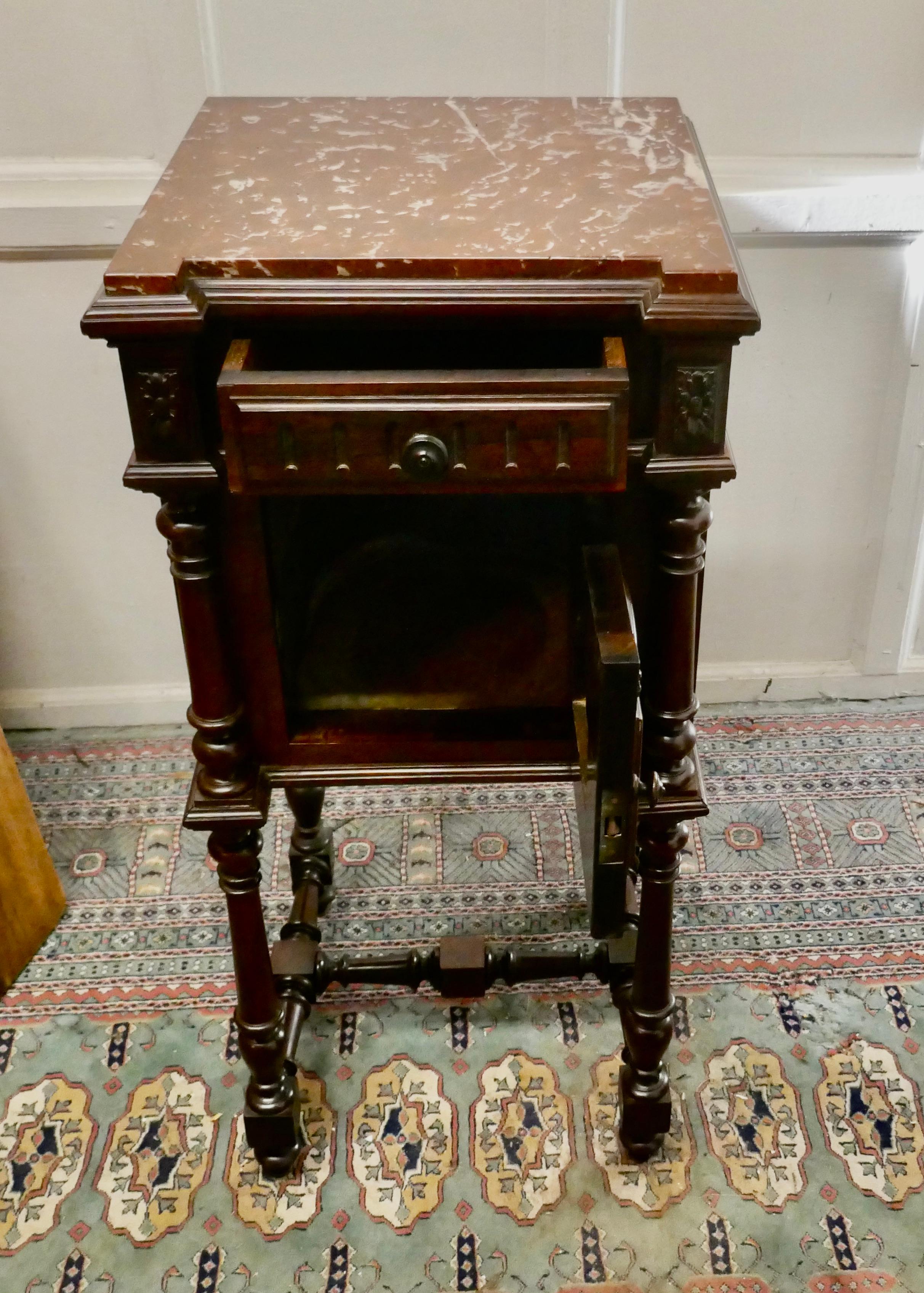 French rosewood night table or side cupboard

This is a very attractive piece of furniture from Brittany, the cabinet has a small drawer at the top with a cupboard beneath and it has attractive turned legs 
The cabinet has a pretty dark pink