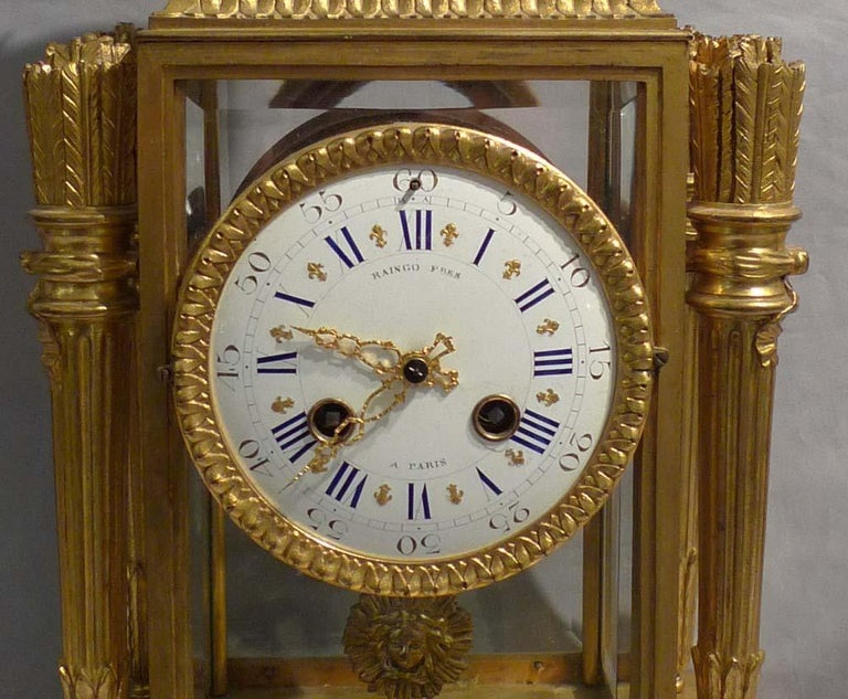 A good antique French ormolu and rouge marble four glass clock by the eminent makers Raingo Freres. The clock with original ormolu is surmounted by an ormolu mounted marble urn with a berry finial to the top. The columns to the four corners of the