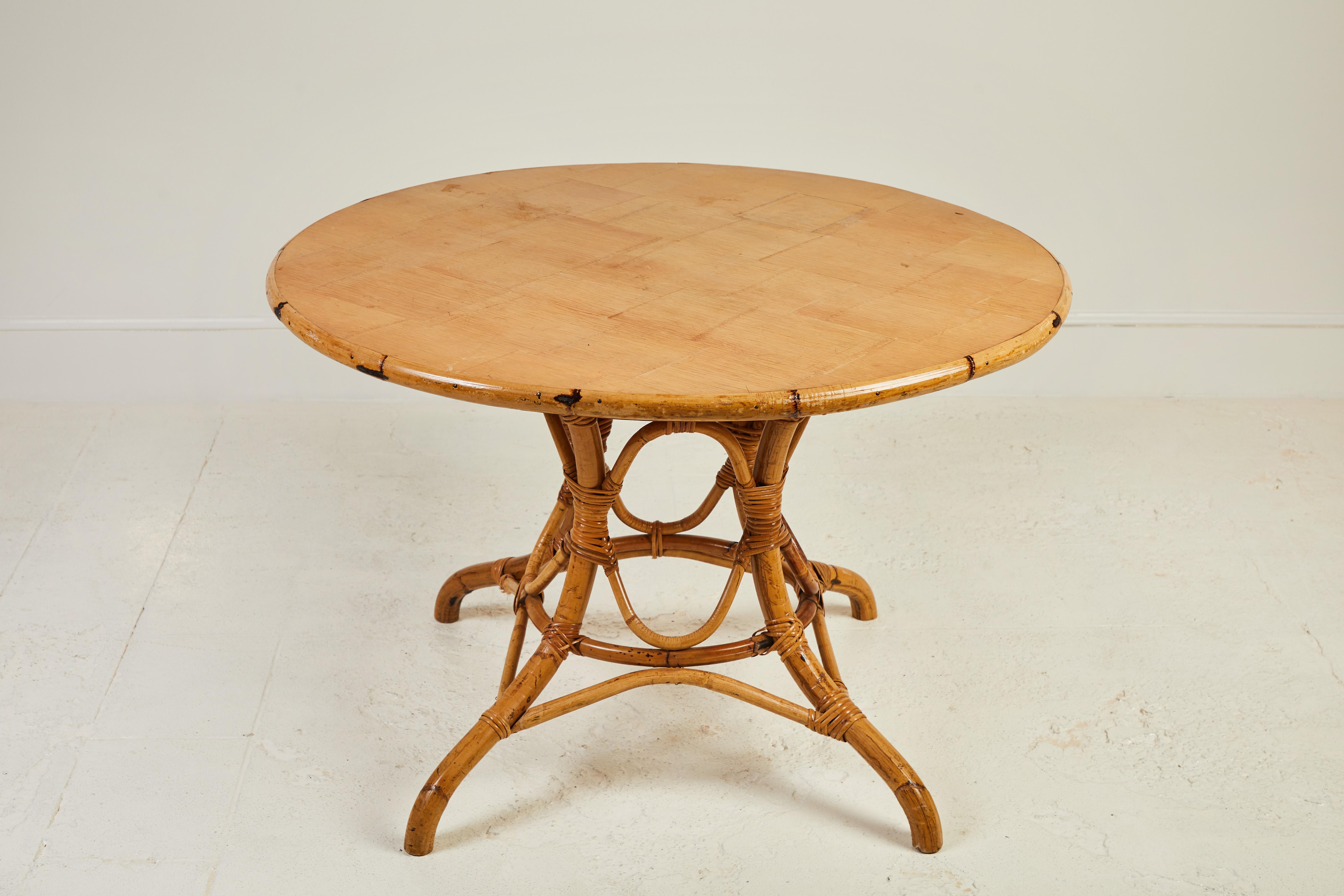 French round bamboo dining table on a pedestal base.