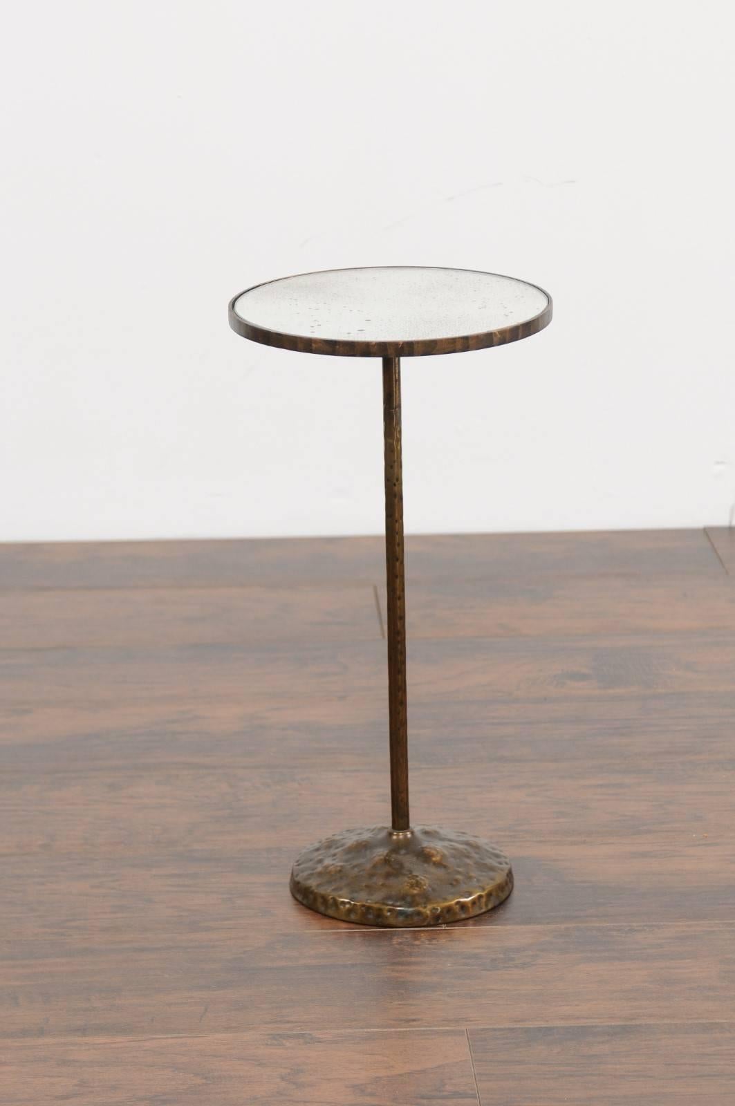 A petite French round copper pedestal drink table from the first half of the 20th century and new mirrored top. This French copper drink table features a circular top, adorned with a new custom-made mirror. The table is raised on a thin pedestal