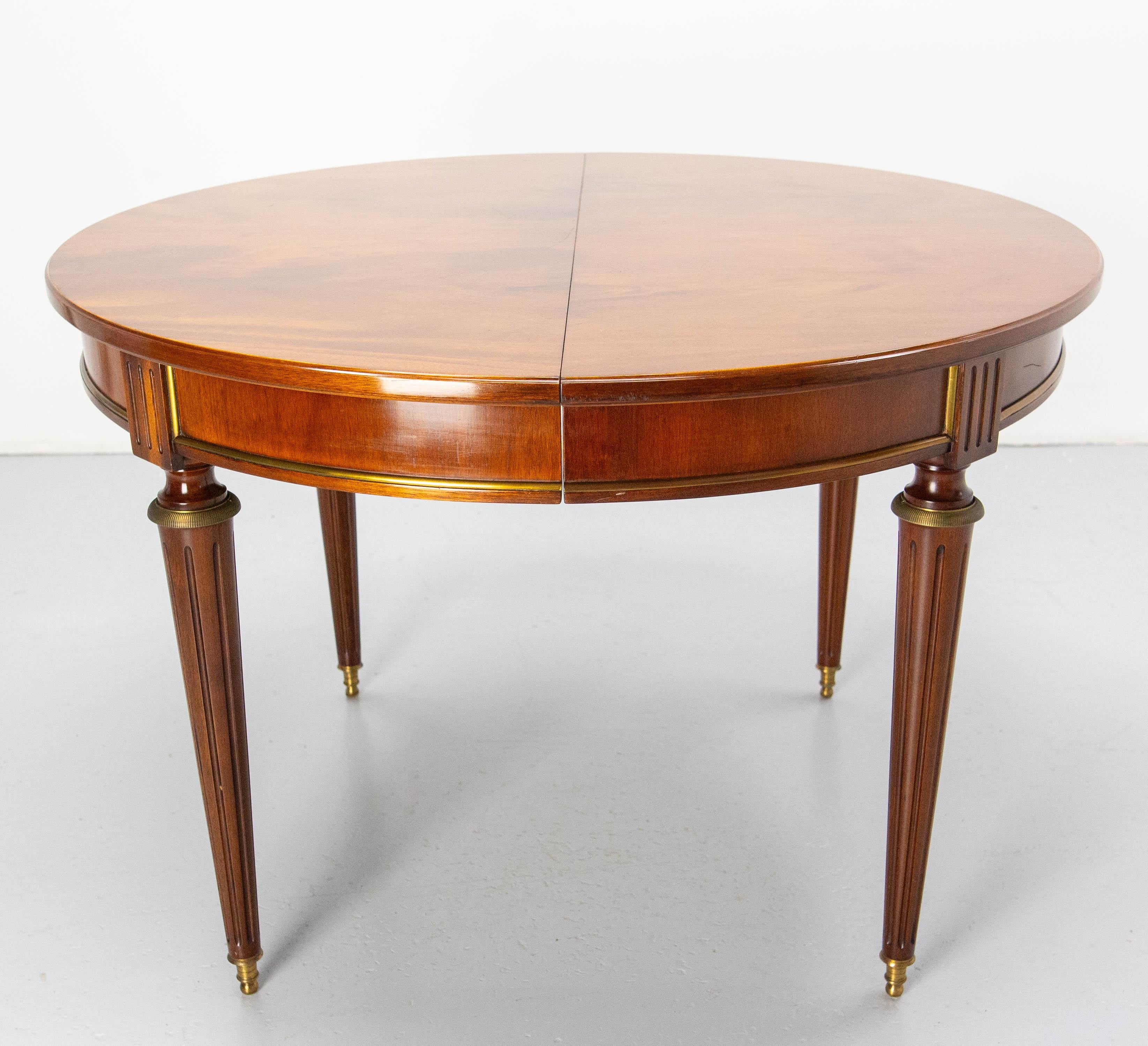 French extending dining table, mid-century in the Louis XVI style.
Iroko wood.

Dimension without the extension: diameter: 43.31 in. (110 cm)
Good condition with very few marks of use on the table (see photo of the top). 

Shipping:
110 / 110 / H 75
