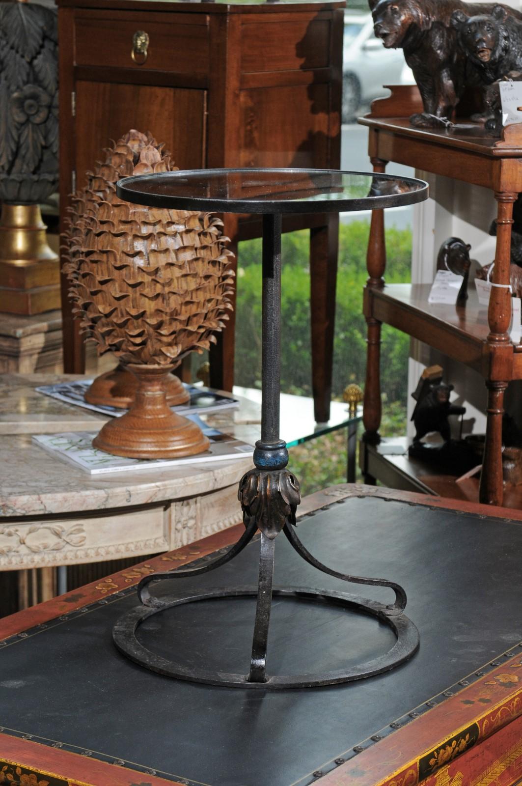 A French drinks table with mirrored top, repurposed from an old 1900s iron lamp. This charming French side table charms us with its stylish base made from an old iron lamp from the early 20th century and accented with foliage motifs in its center.