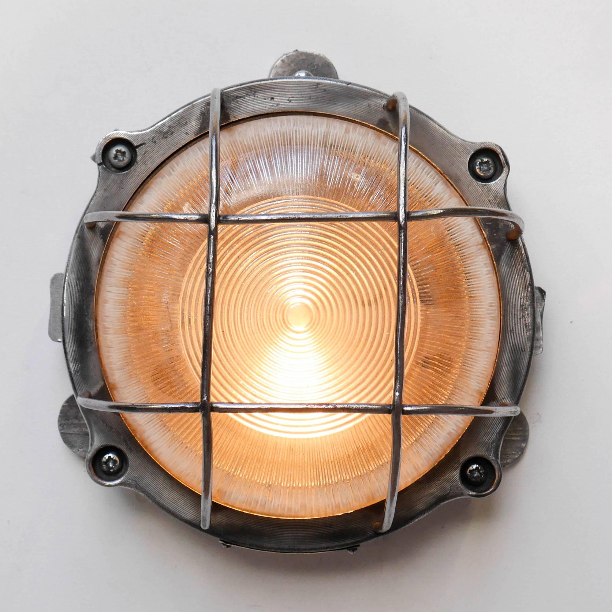 Old industrial wall light, in die-cast aluminium, picked and polished, striped glass offering a good diffusion of light.

 