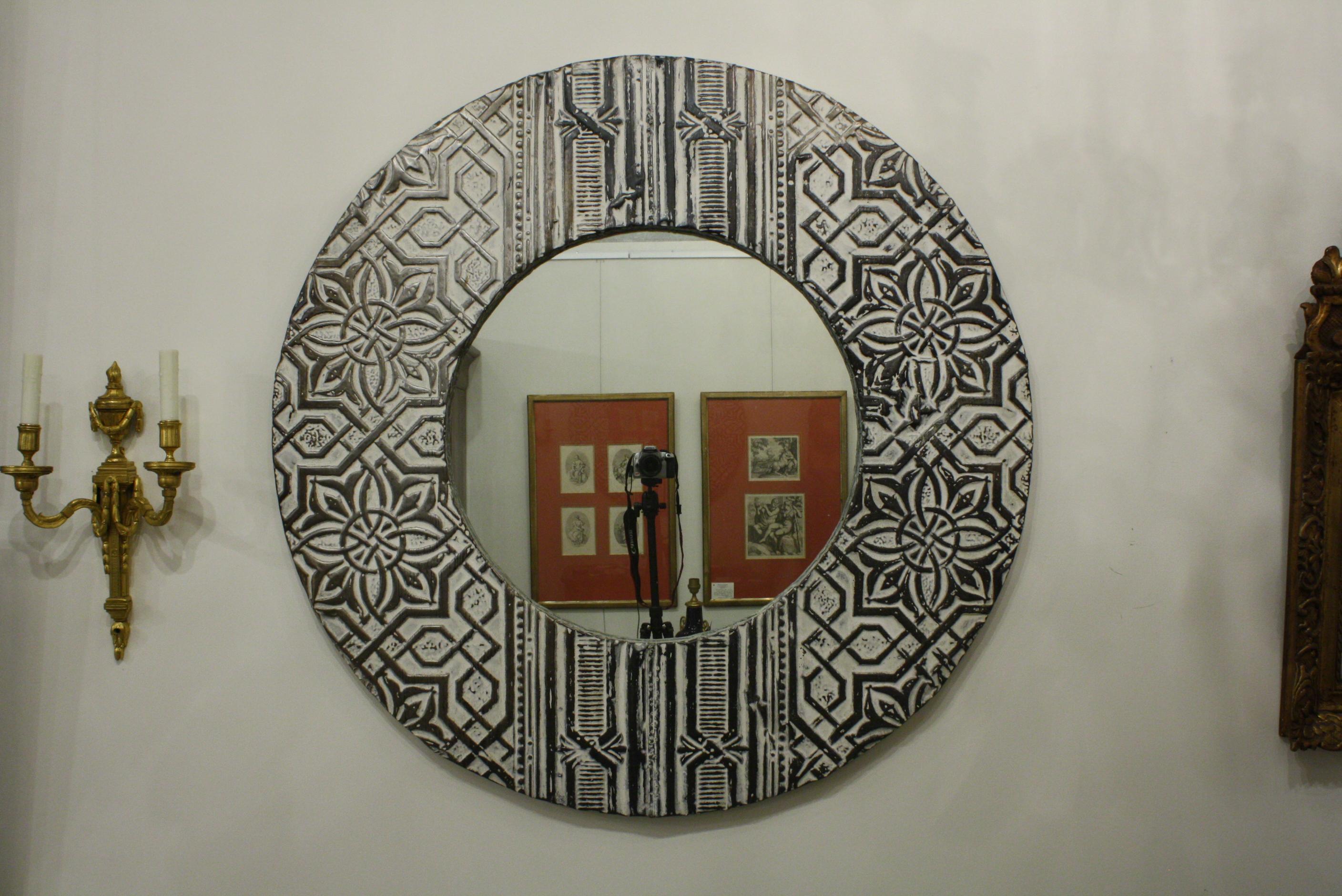 A highly decorative French mirror made from Art Deco white-painted tin ceiling tiles. The overall diameter is 44