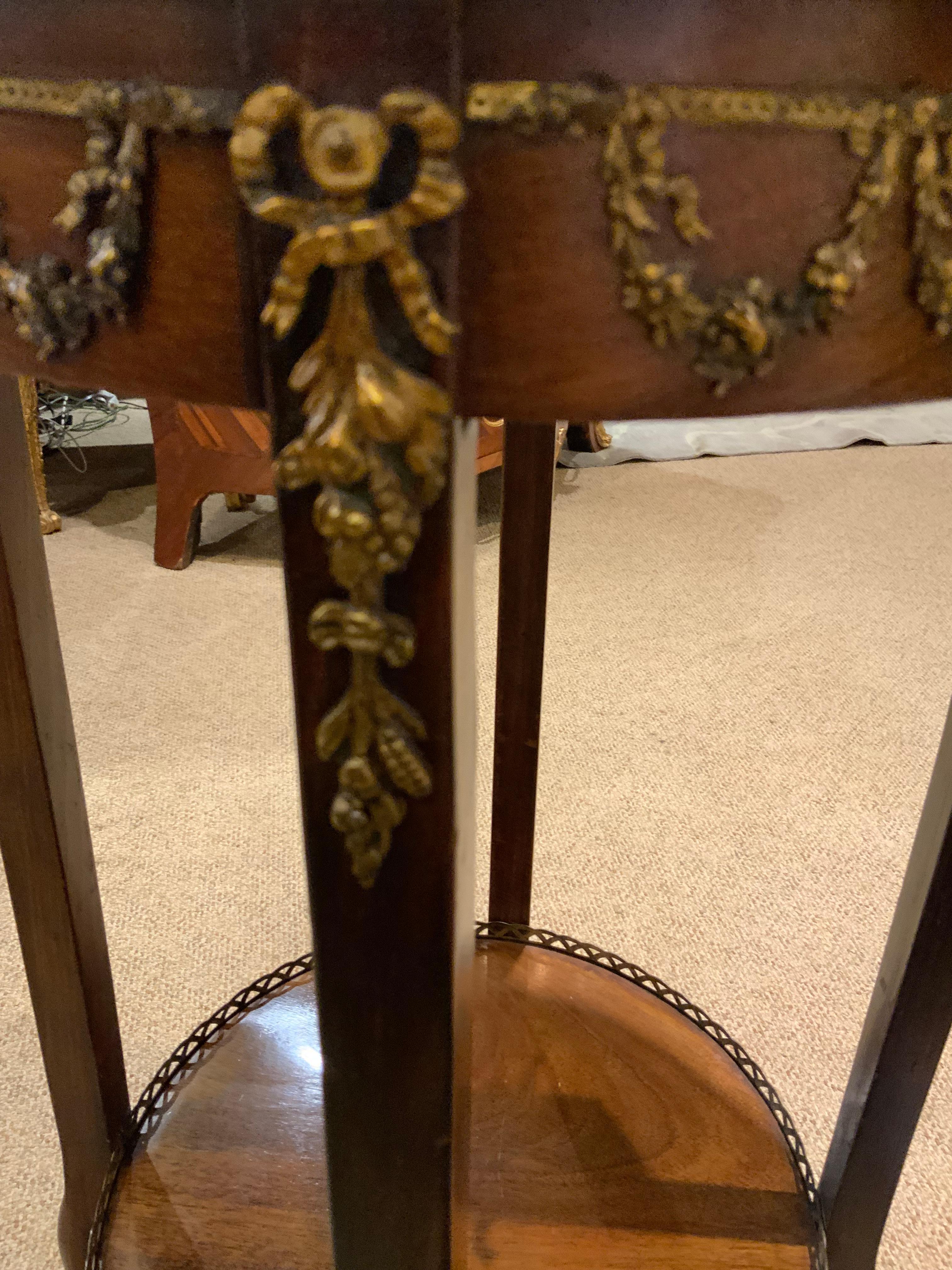 Fine detail work on this table makes it highly desirable. The bronze
Mounts are in a foliate design surrounding the edge of the table
And a fine bow and scroll flow downward on each leg. The rouge
Marble top is in great condition.