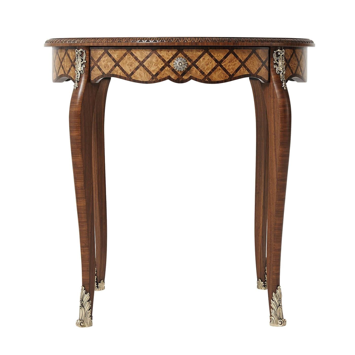French round parquetry side table with yew burl and Morado parquetry, the circular egg and dart carved edge top above an undulating frieze and drawer with flowerhead cast brass handles, on curved front Morado veneered cabriole legs with cartouche