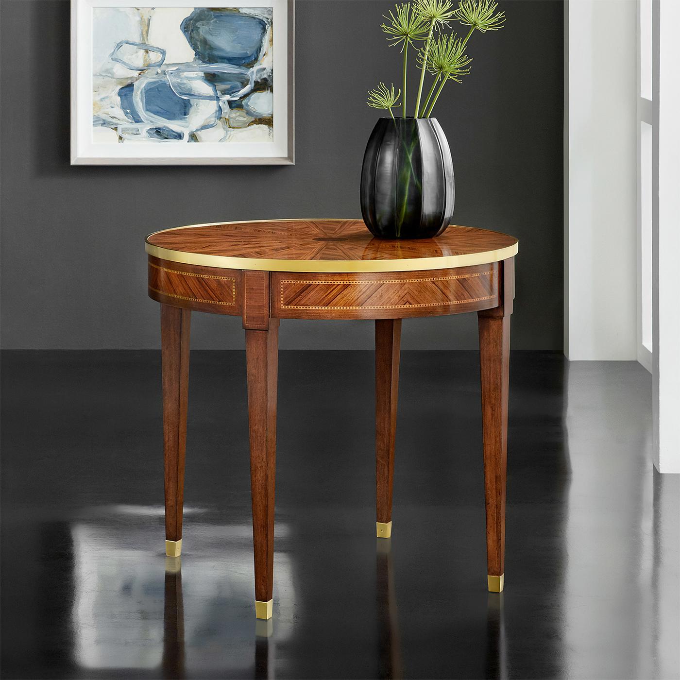 French Round Side Table, in the Neo Classic Louis XVI Style, this parquetry inlaid side table has a top with a rayed marquetry design and brass trim, the frieze crossbanded with inlay and raised on square tapered legs with brass