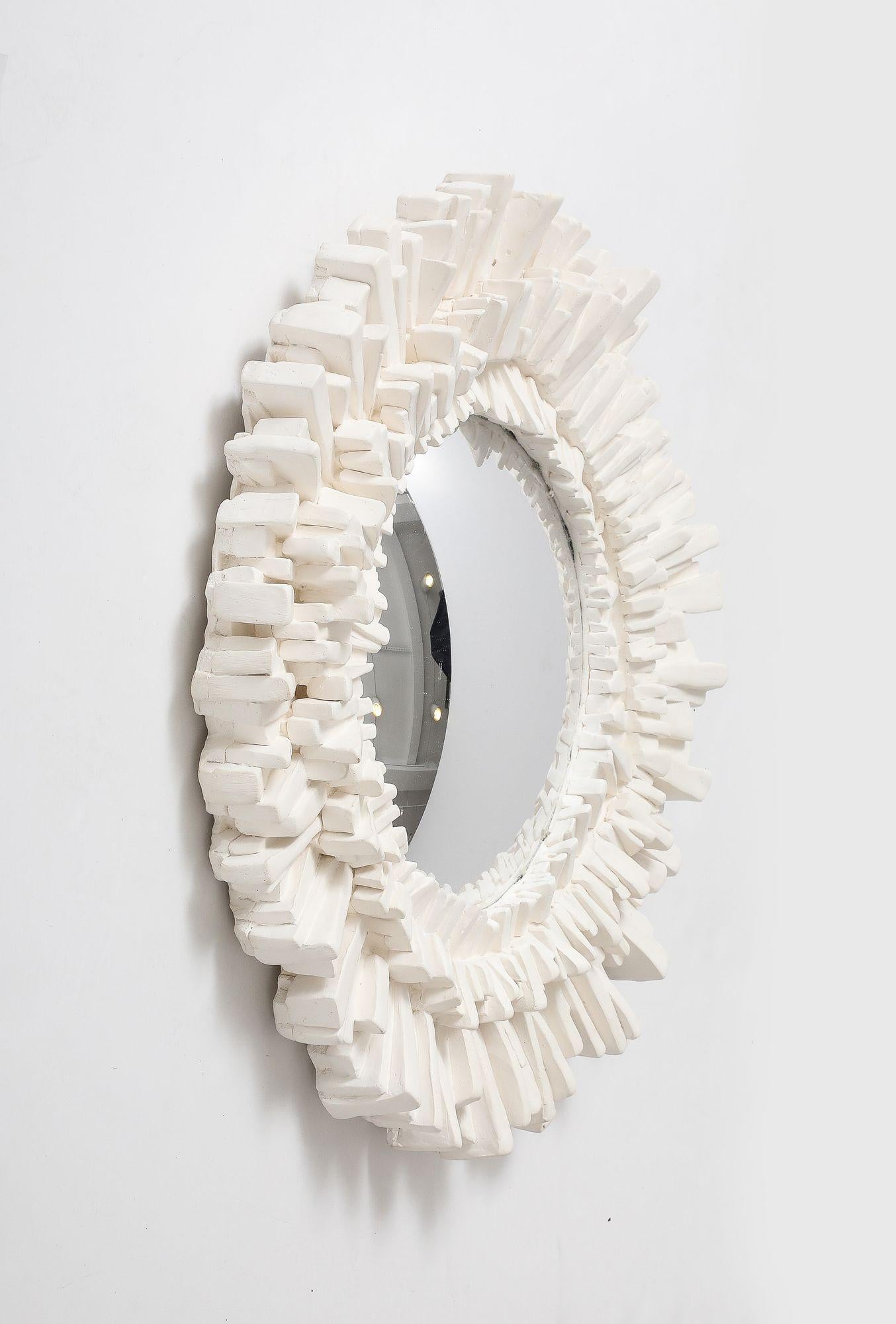 Circa 2020 Contemporary made French plaster starburst shaped mirror with round mirror plate. The frame features various lengths of layered starburst rays. Made in France. Please note of wear consistent with age. 22